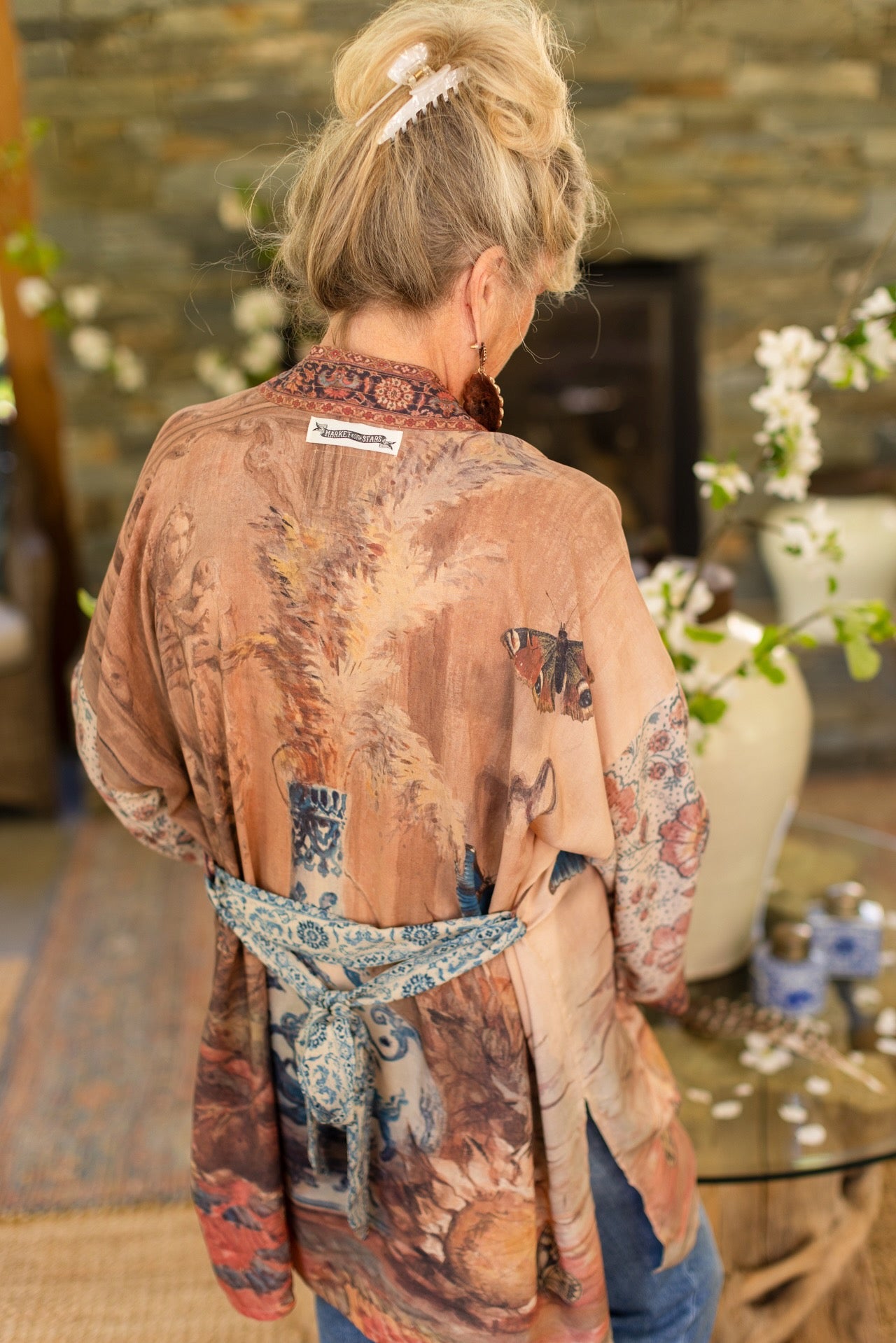 Model(s) wearing The Storyteller -- a mid-length Matinée kimono duster featuring antique artwork and vintage prints from around the world -- Market of Stars
