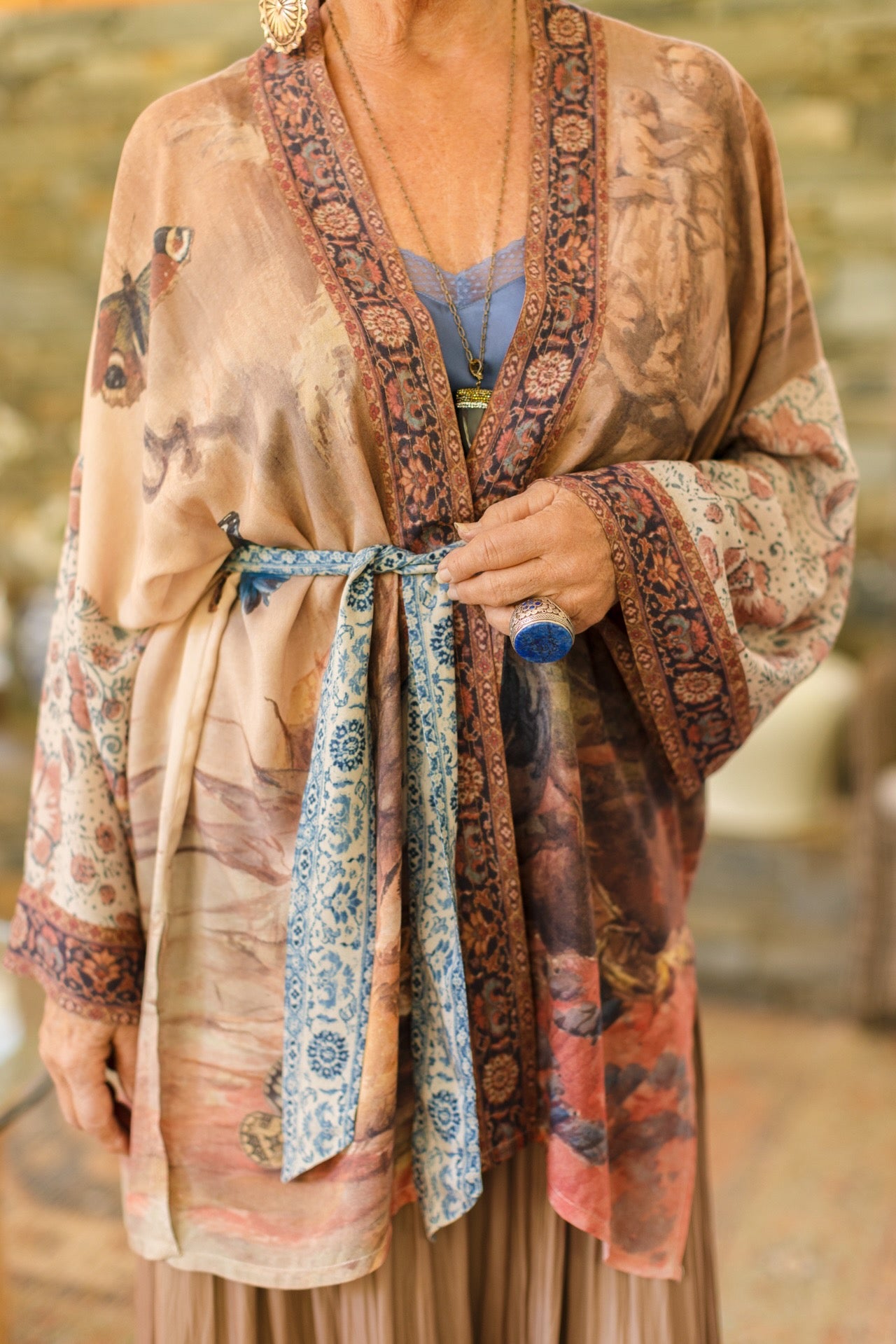 Model(s) wearing The Storyteller -- a mid-length Matinée kimono duster featuring antique artwork and vintage prints from around the world -- Market of Stars