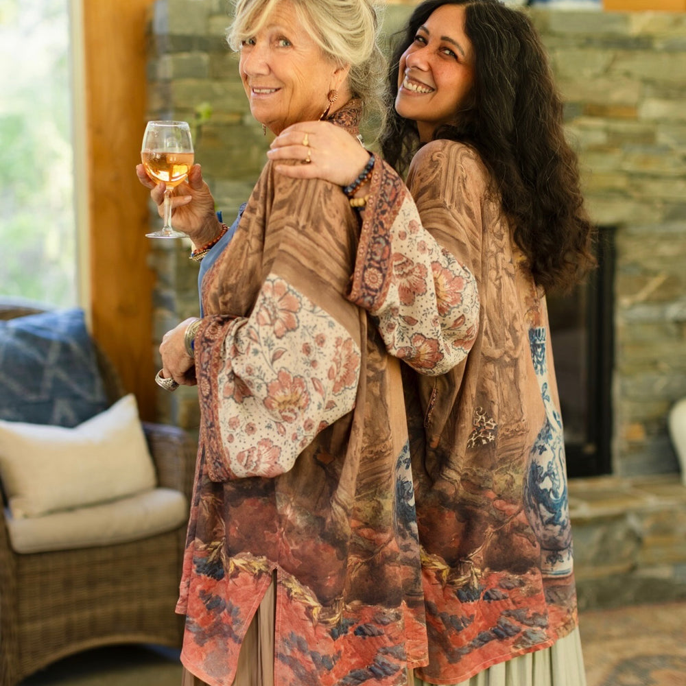 
                  
                    Model(s) wearing The Storyteller -- a mid-length Matinée kimono duster featuring antique artwork and vintage prints from around the world -- Market of Stars
                  
                
