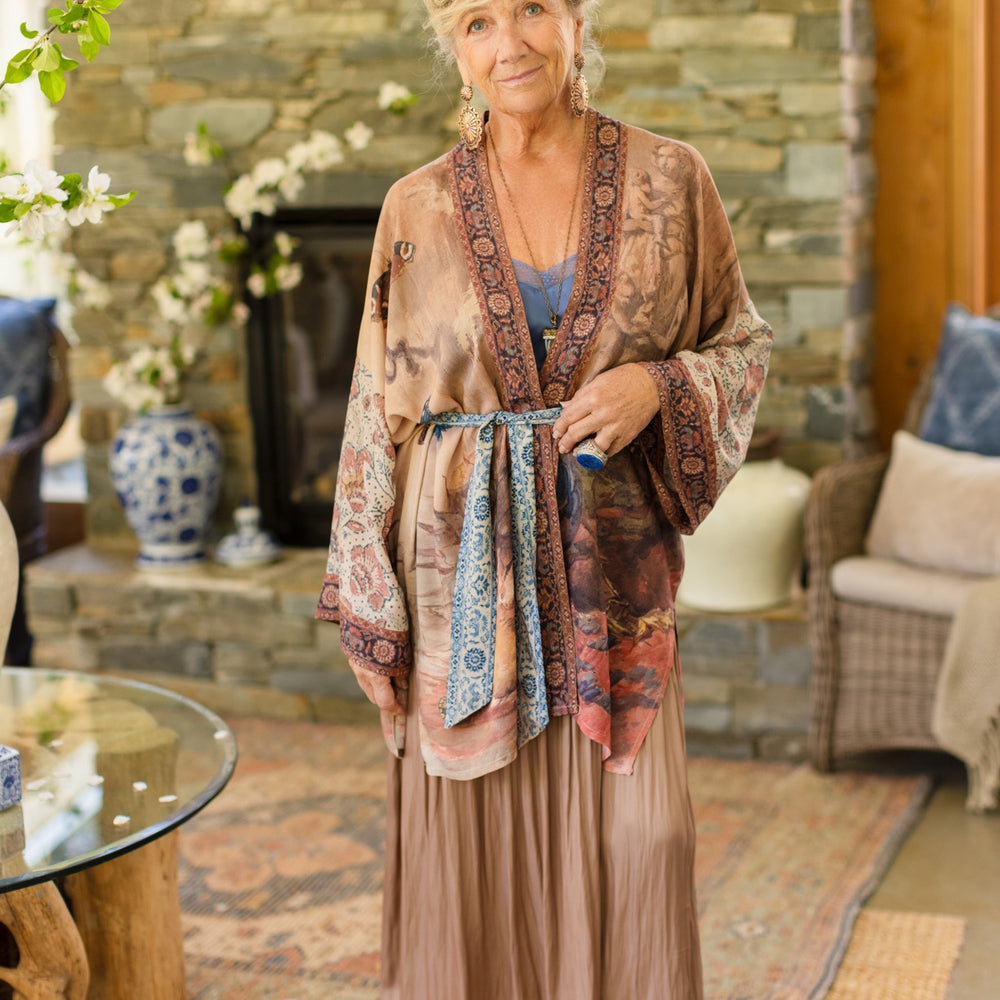 
                  
                    Model(s) wearing The Storyteller -- a mid-length Matinée kimono duster featuring antique artwork and vintage prints from around the world -- Market of Stars
                  
                