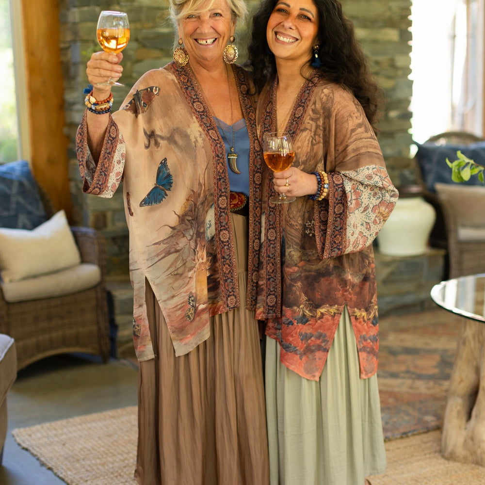 
                  
                    Model(s) wearing The Storyteller -- a mid-length Matinée kimono duster featuring antique artwork and vintage prints from around the world -- Market of Stars
                  
                