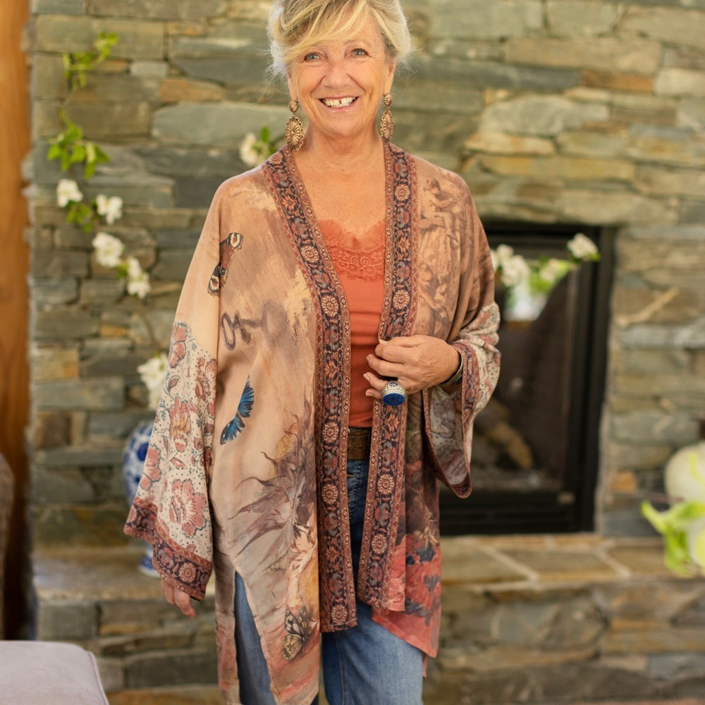 
                  
                    Model(s) wearing The Storyteller -- a mid-length Matinée kimono duster featuring antique artwork and vintage prints from around the world -- Market of Stars
                  
                