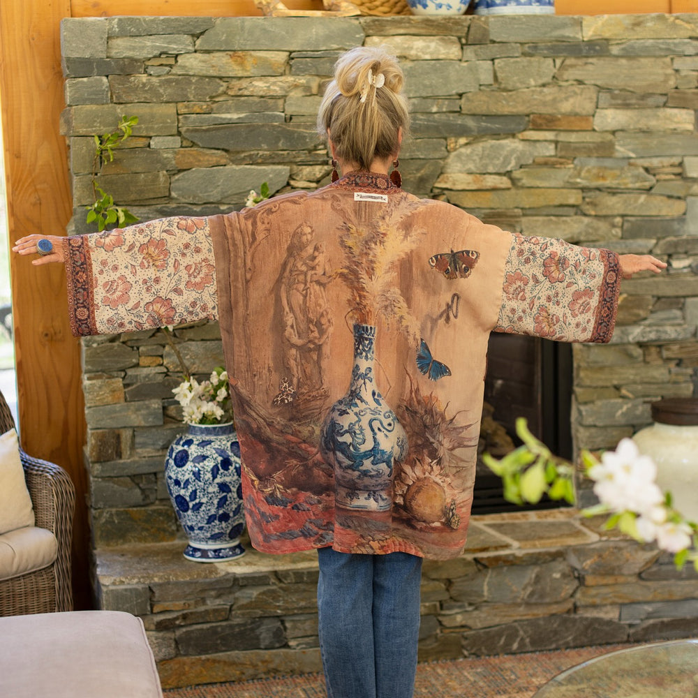 
                  
                    Model(s) wearing The Storyteller -- a mid-length Matinée kimono duster featuring antique artwork and vintage prints from around the world -- Market of Stars
                  
                