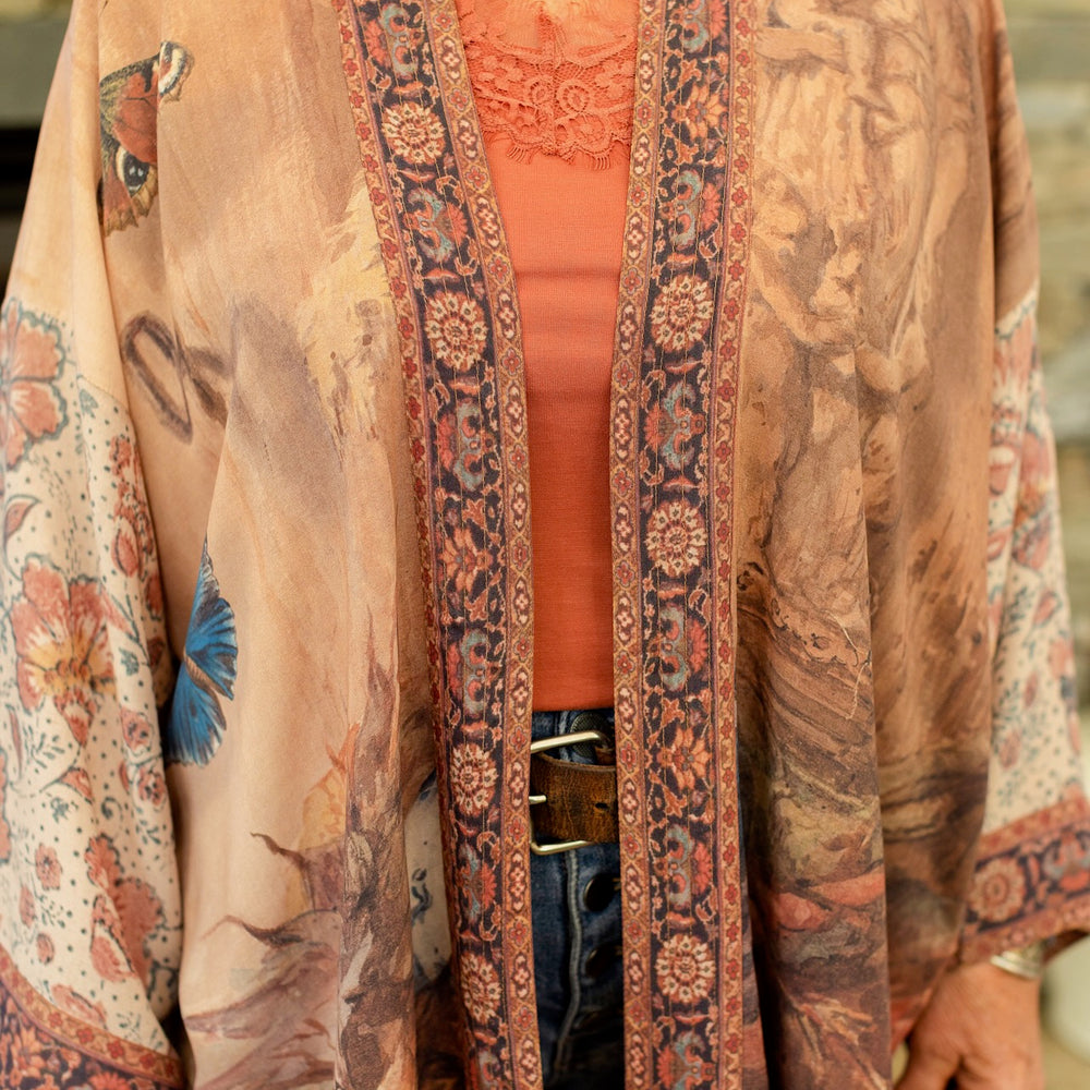
                  
                    Model(s) wearing The Storyteller -- a mid-length Matinée kimono duster featuring antique artwork and vintage prints from around the world -- Market of Stars
                  
                