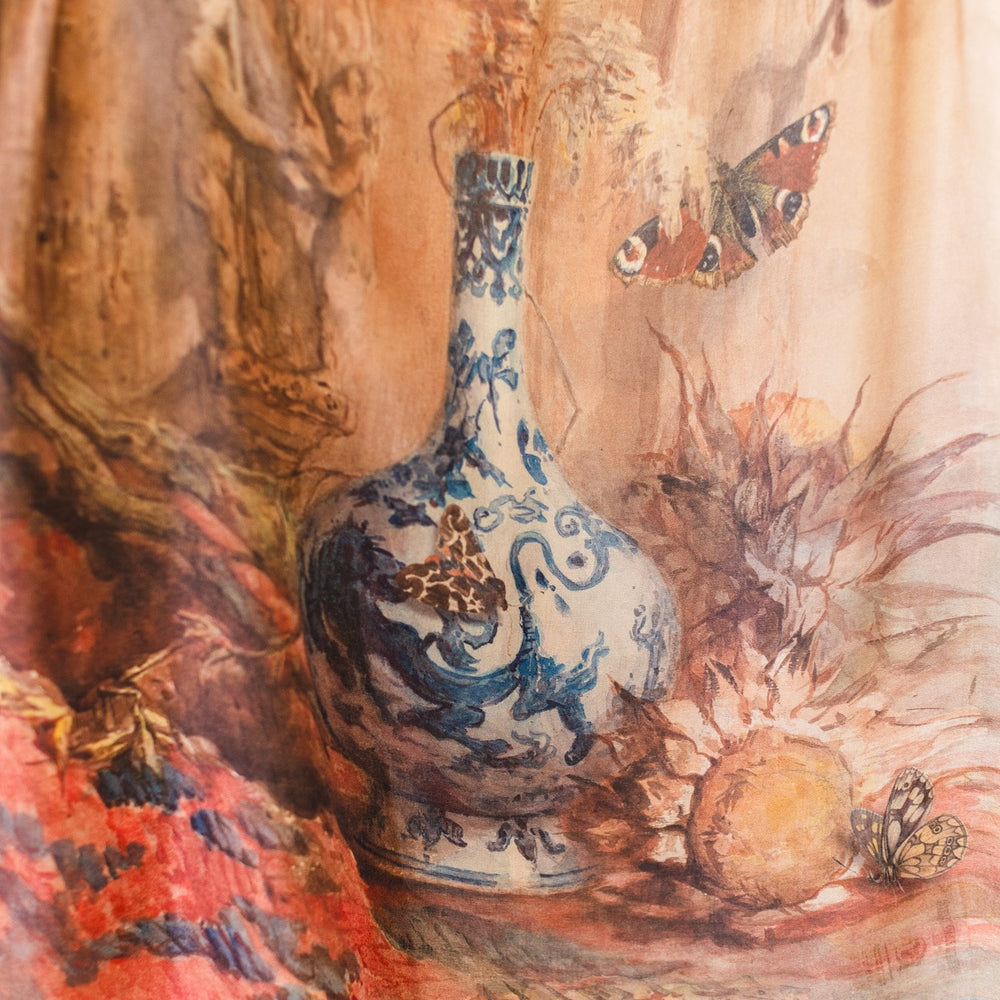 
                  
                    Model wearing lightweight Storyteller scarf, featuring antique watercolour artwork and a mixture of prints from around the world -- Market of Stars
                  
                
