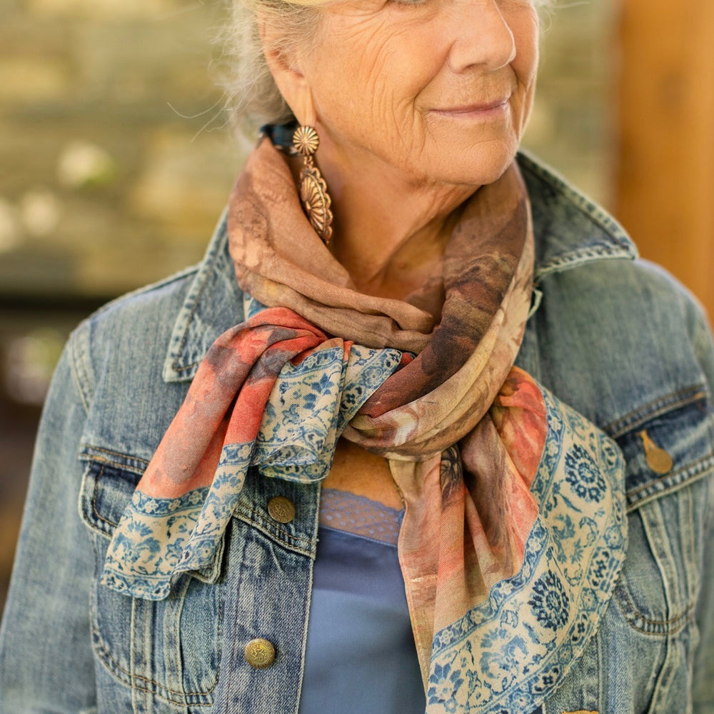 
                  
                    Model wearing lightweight Storyteller scarf, featuring antique watercolour artwork and a mixture of prints from around the world -- Market of Stars
                  
                