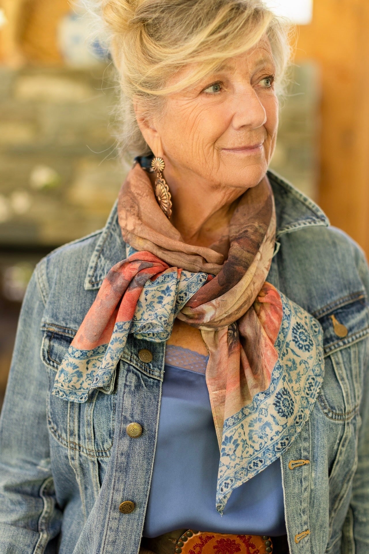 Model wearing lightweight Storyteller scarf, featuring antique watercolour artwork and a mixture of prints from around the world -- Market of Stars