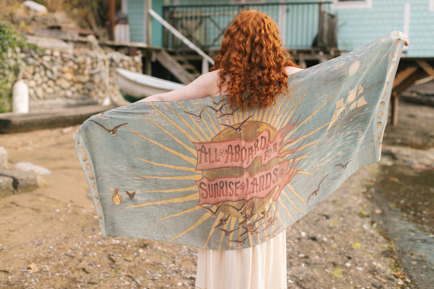 Lightweight scarf featuring a dreamy sunrise landscape and nautical artwork with the words 