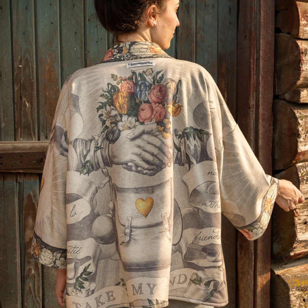 A cozy cardigan lined in fleece featuring Victorian collage artwork and the phrase “Life is nothing without friendship” – Market of Stars