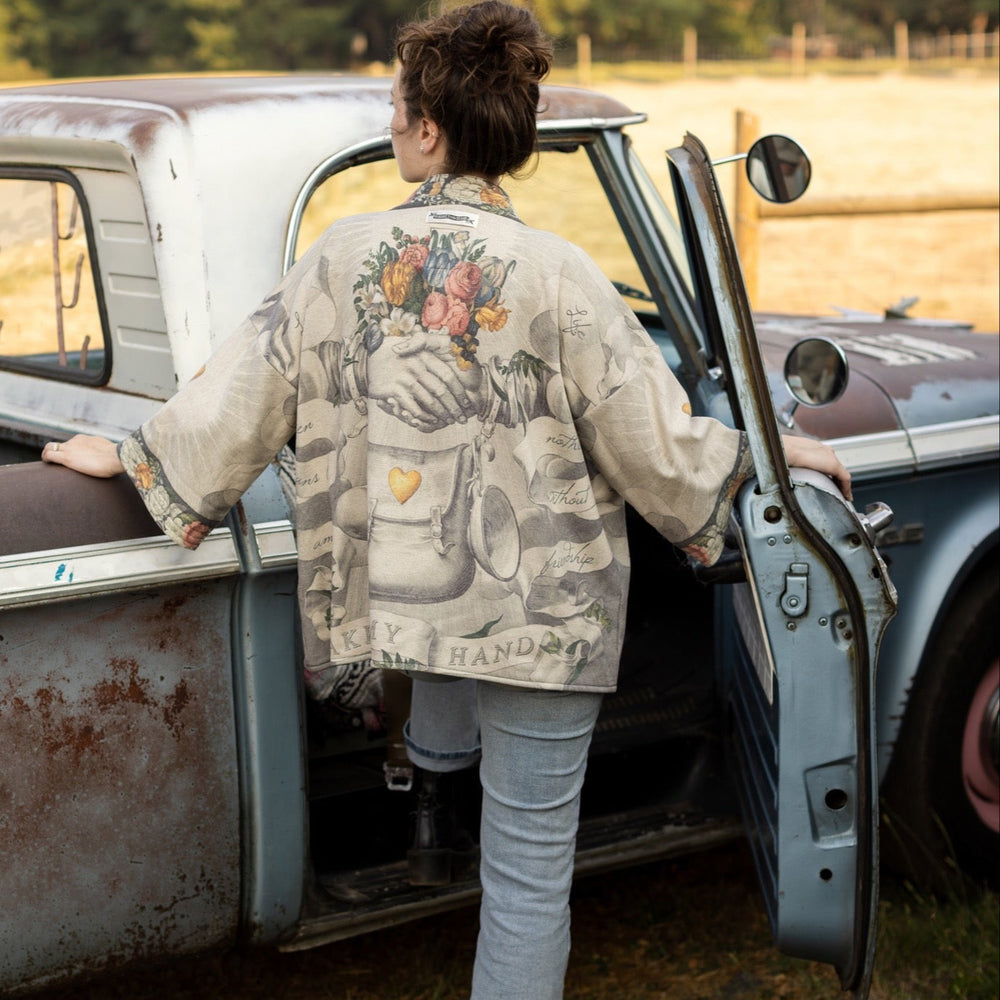 
                  
                    A cozy cardigan lined in fleece featuring Victorian collage artwork and the phrase “Life is nothing without friendship” – Market of Stars
                  
                
