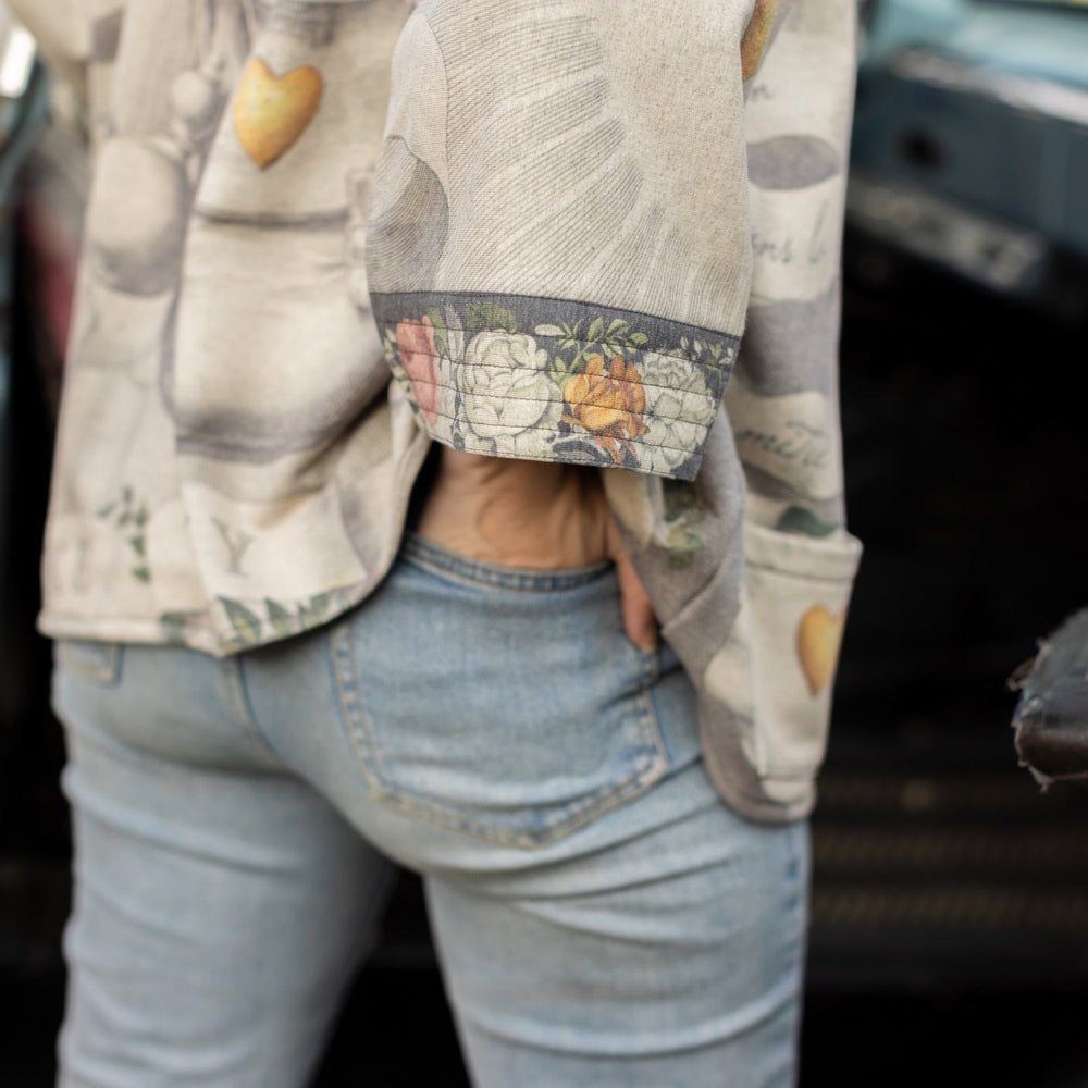 
                  
                    A cozy cardigan lined in fleece featuring Victorian collage artwork and the phrase “Life is nothing without friendship” – Market of Stars
                  
                