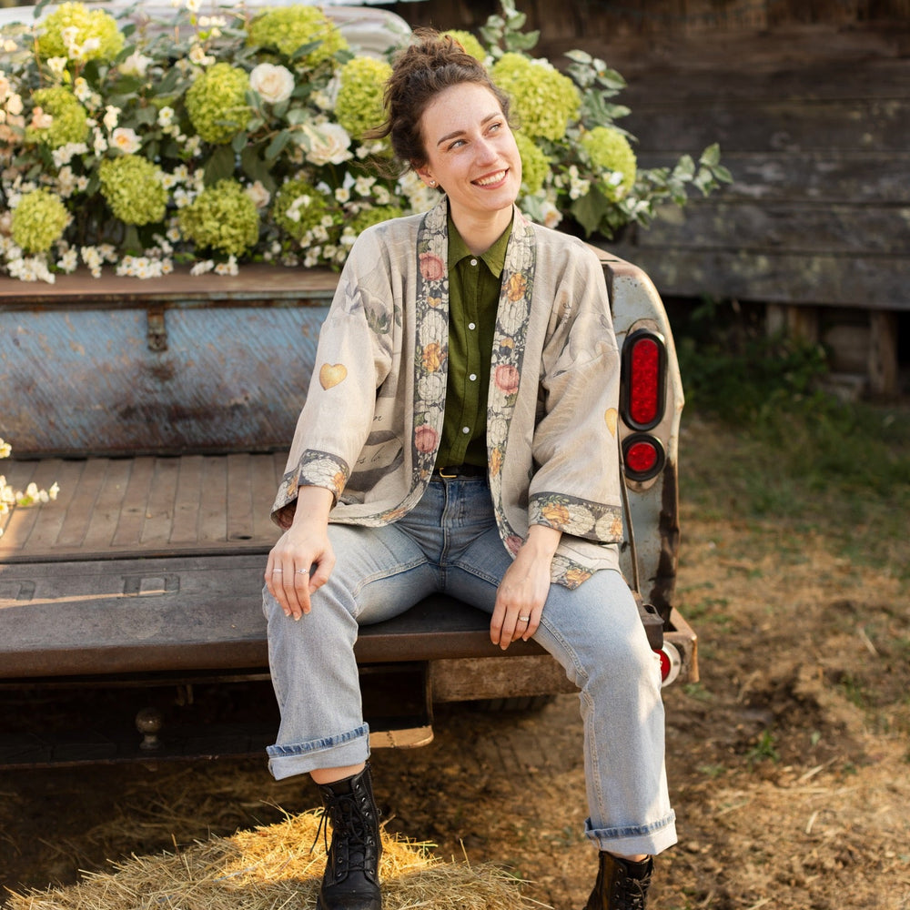 
                  
                    A cozy cardigan lined in fleece featuring Victorian collage artwork and the phrase “Life is nothing without friendship” – Market of Stars
                  
                