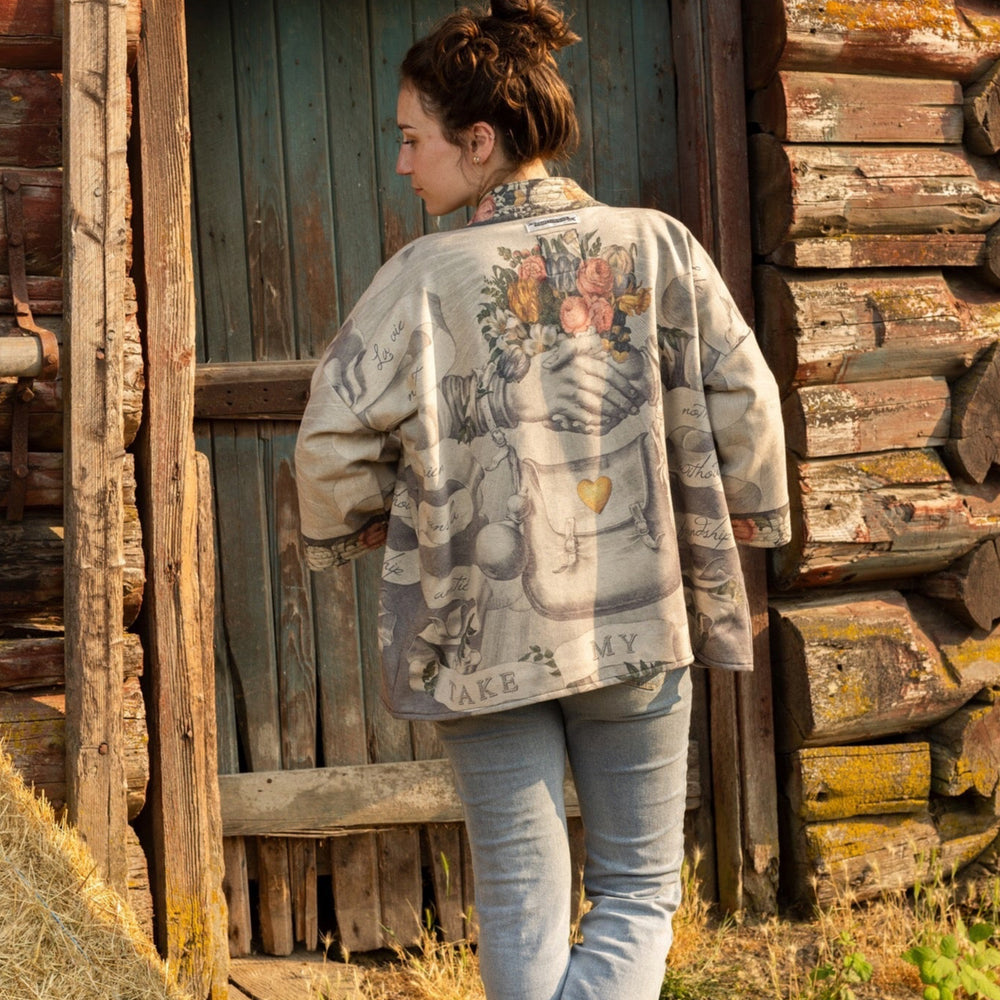 
                  
                    A cozy cardigan lined in fleece featuring Victorian collage artwork and the phrase “Life is nothing without friendship” – Market of Stars
                  
                