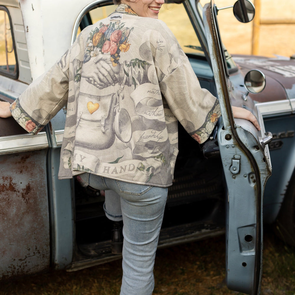 
                  
                    A cozy cardigan lined in fleece featuring Victorian collage artwork and the phrase “Life is nothing without friendship” – Market of Stars
                  
                