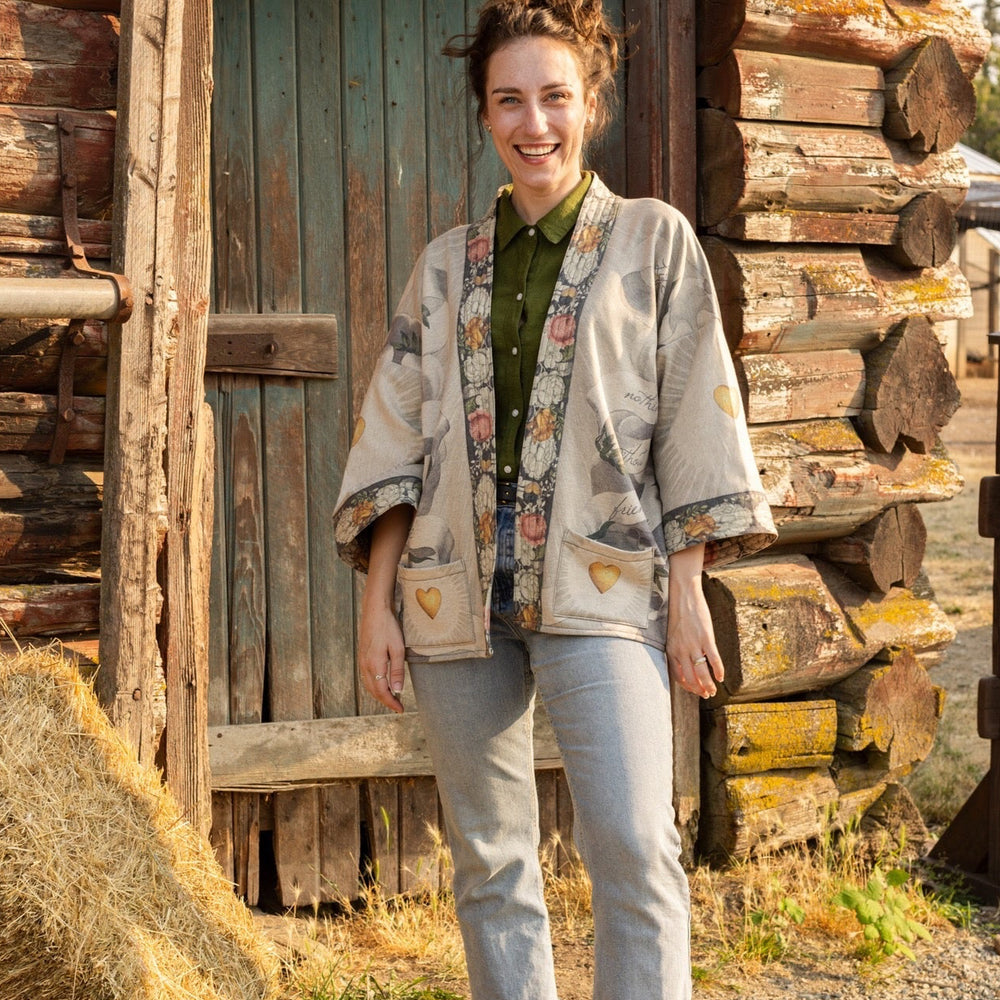 
                  
                    A cozy cardigan lined in fleece featuring Victorian collage artwork and the phrase “Life is nothing without friendship” – Market of Stars
                  
                