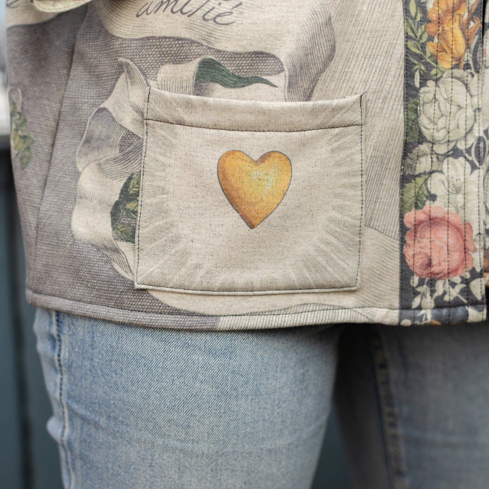 
                  
                    A cozy cardigan lined in fleece featuring Victorian collage artwork and the phrase “Life is nothing without friendship” – Market of Stars
                  
                