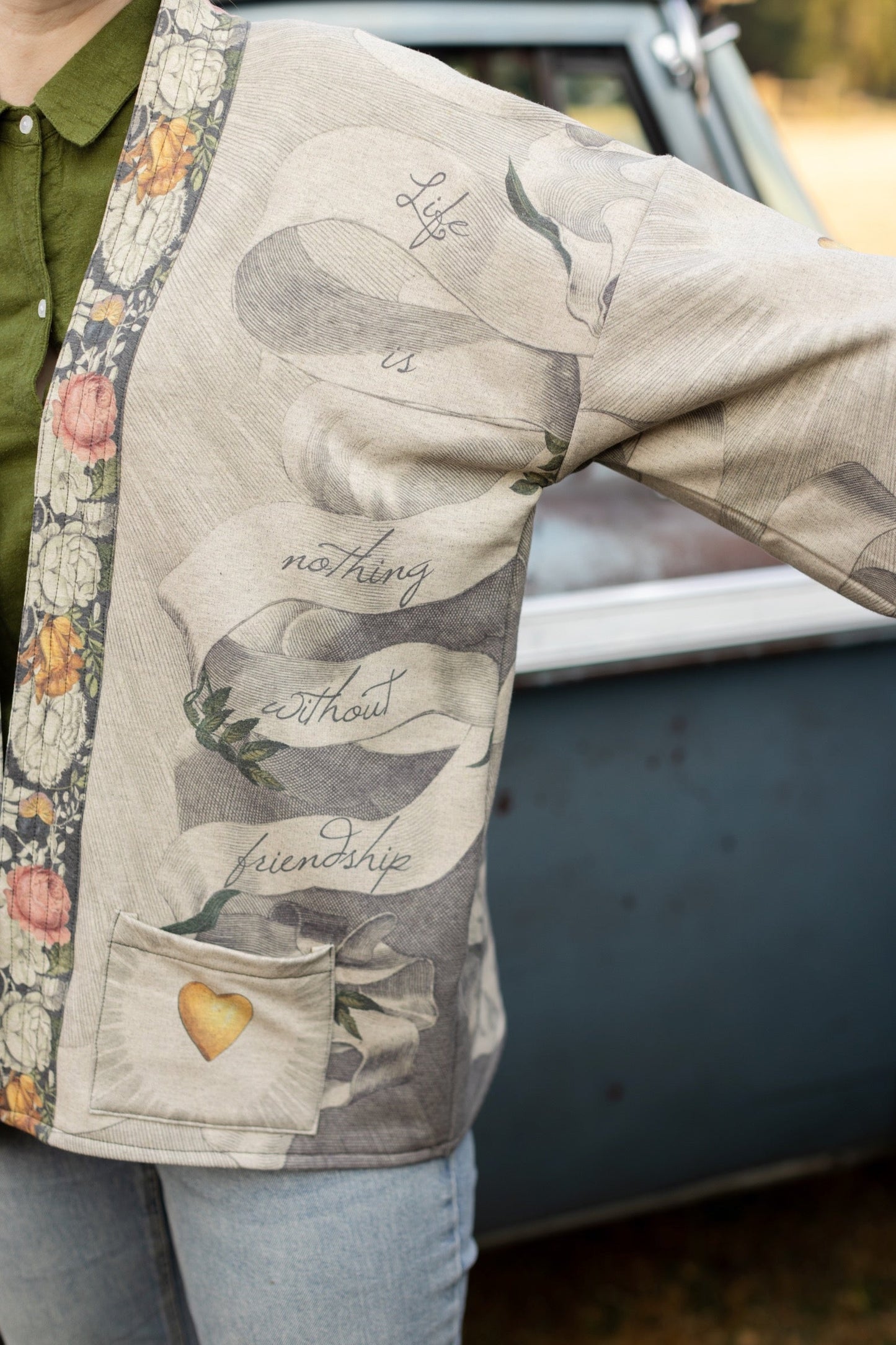 A cozy cardigan lined in fleece featuring Victorian collage artwork and the phrase “Life is nothing without friendship” – Market of Stars