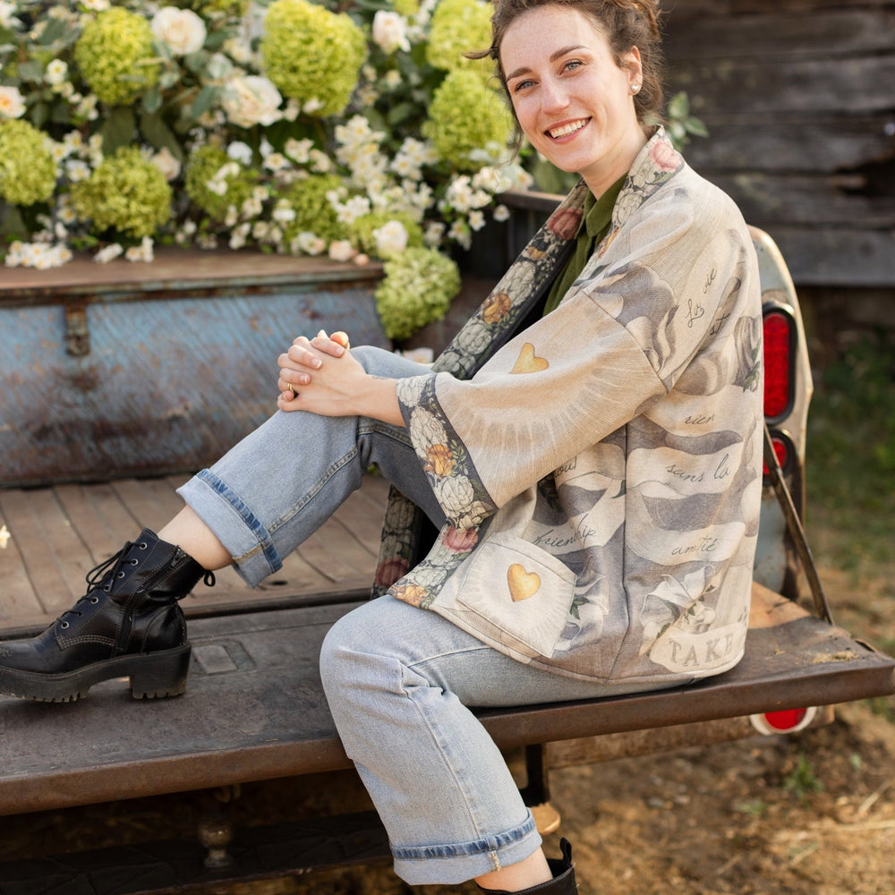 
                  
                    A cozy cardigan lined in fleece featuring Victorian collage artwork and the phrase “Life is nothing without friendship” – Market of Stars
                  
                