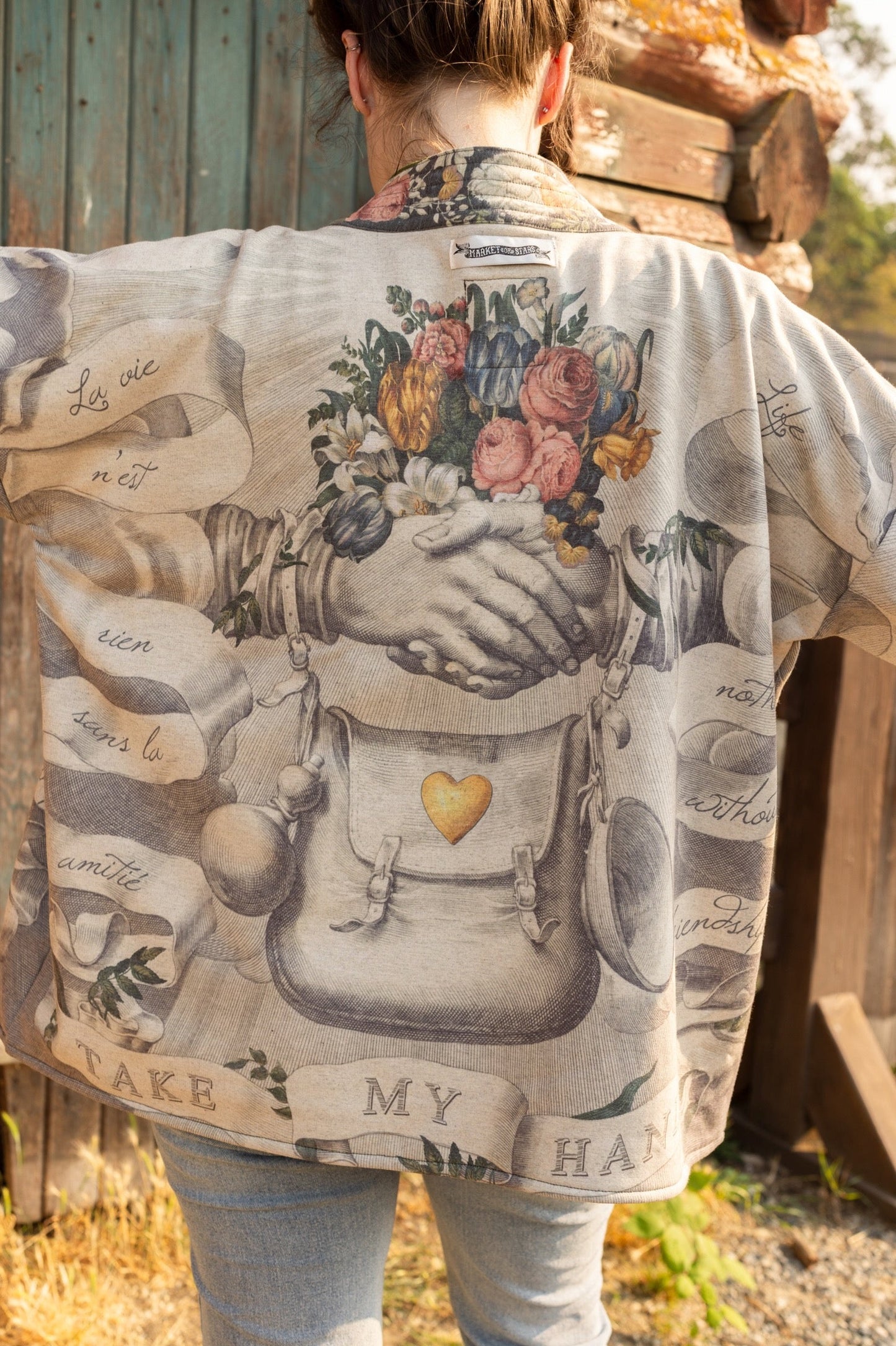 A cozy cardigan lined in fleece featuring Victorian collage artwork and the phrase “Life is nothing without friendship” – Market of Stars