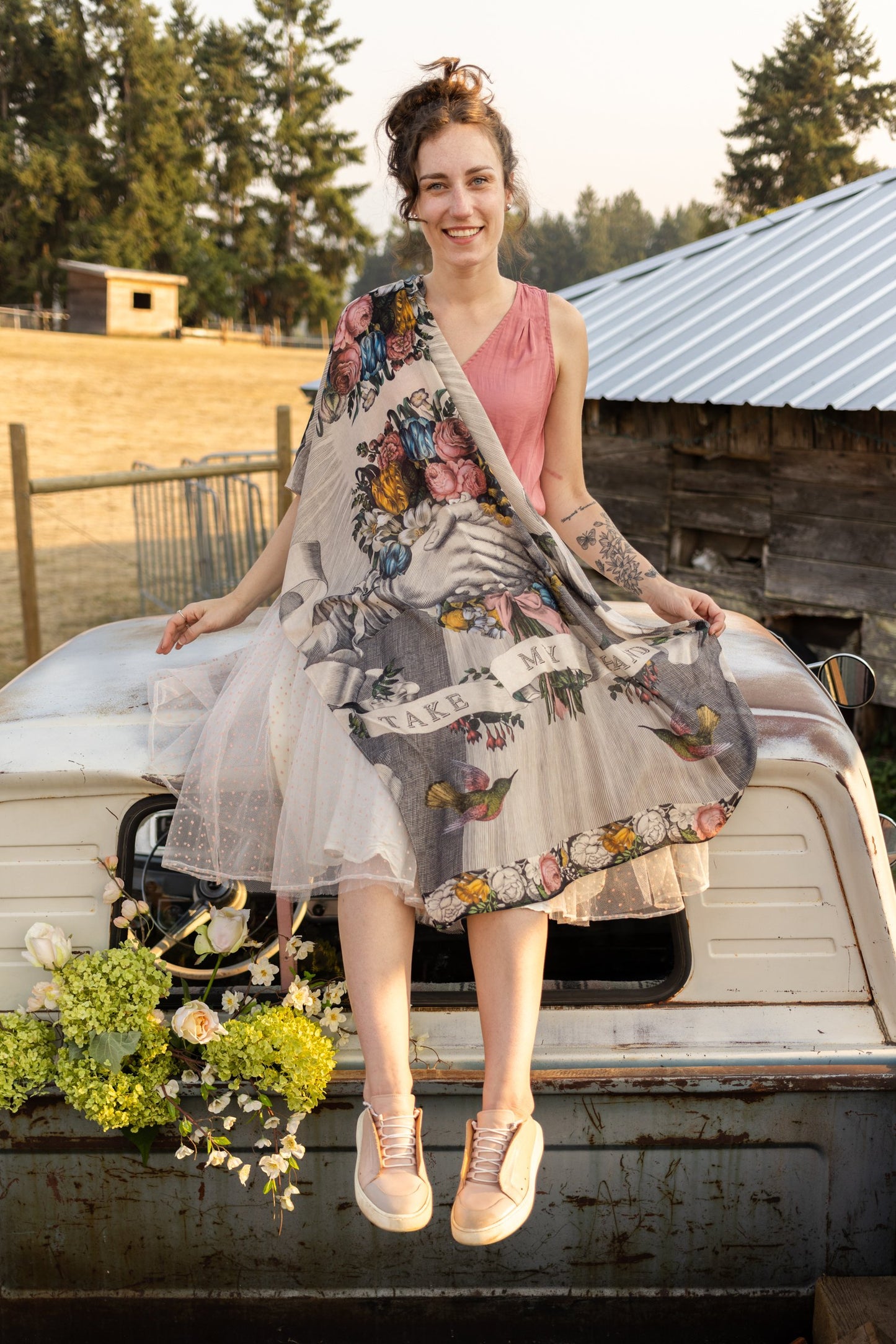 Model wearing Take My Hand scarf with 1600s hand engraving of clasped hands, a painted heart, florals and sun rays – Market of Stars