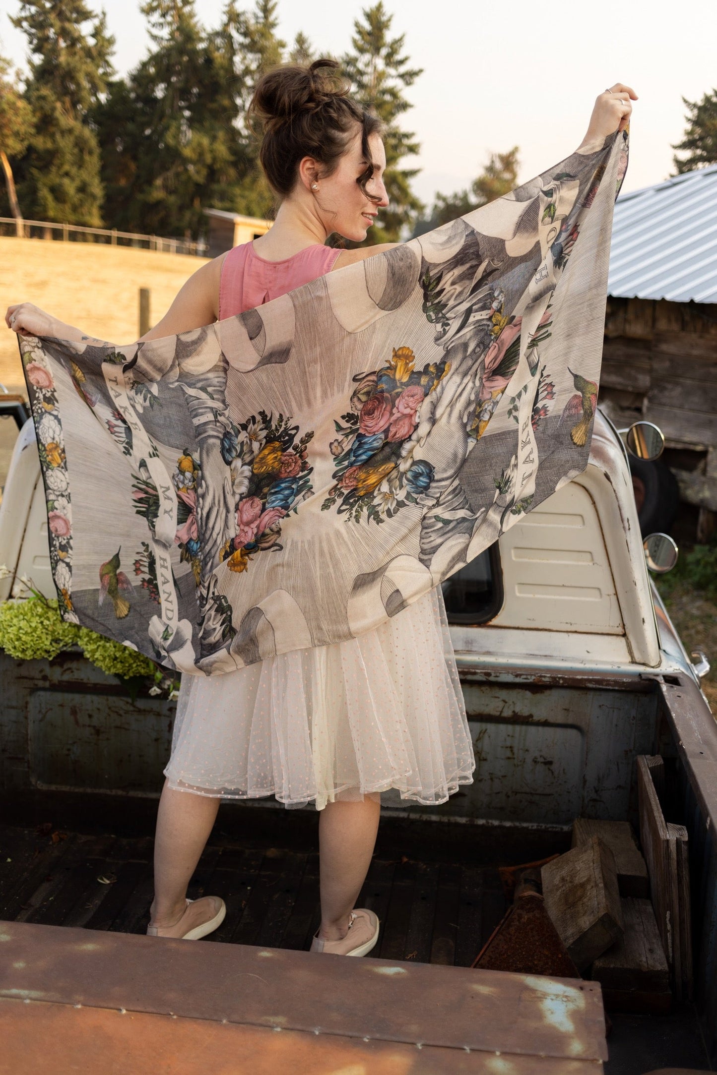 Model wearing Take My Hand scarf with 1600s hand engraving of clasped hands, a painted heart, florals and sun rays – Market of Stars