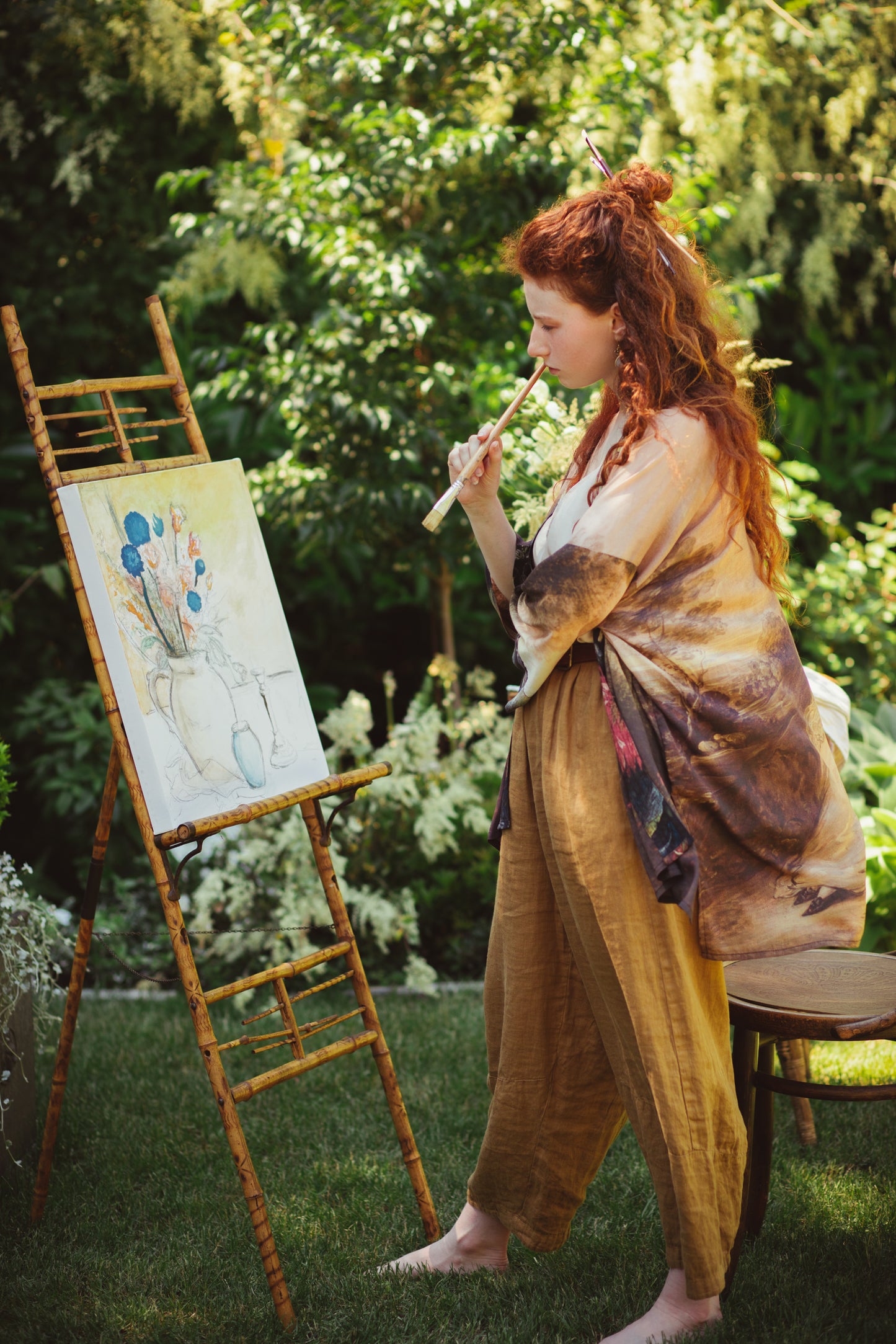 Model wearing The Artist kimono-style duster featuring antique paintings, botanical floral trim, and a radiant golden sun – Market of Stars