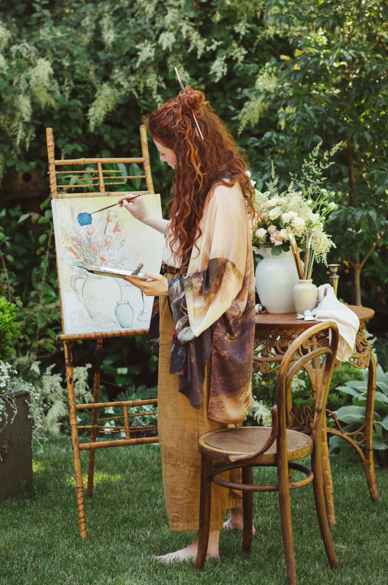 Model wearing The Artist kimono-style duster featuring antique paintings, botanical floral trim, and a radiant golden sun – Market of Stars