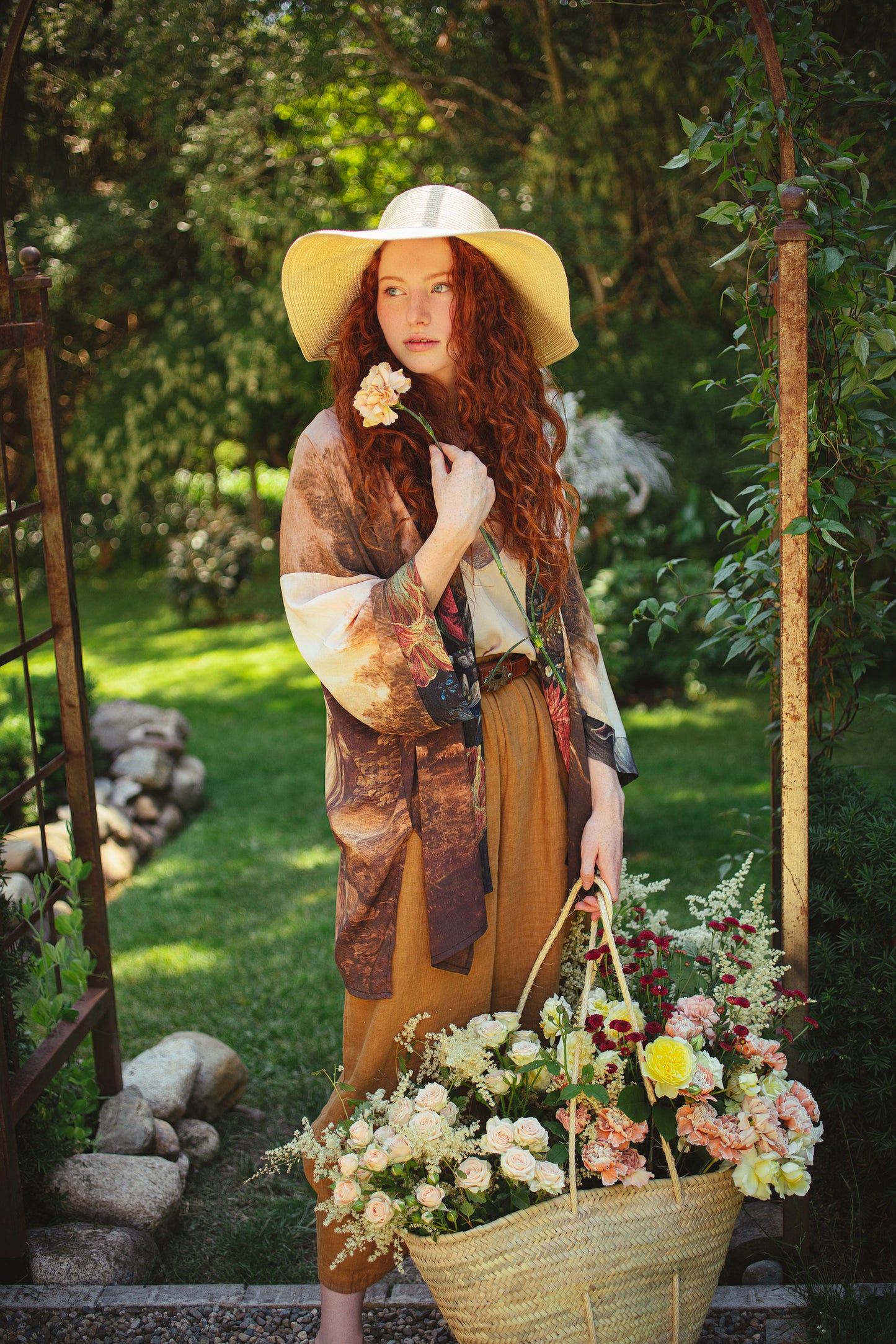 Model wearing The Artist kimono-style duster featuring antique paintings, botanical floral trim, and a radiant golden sun – Market of Stars