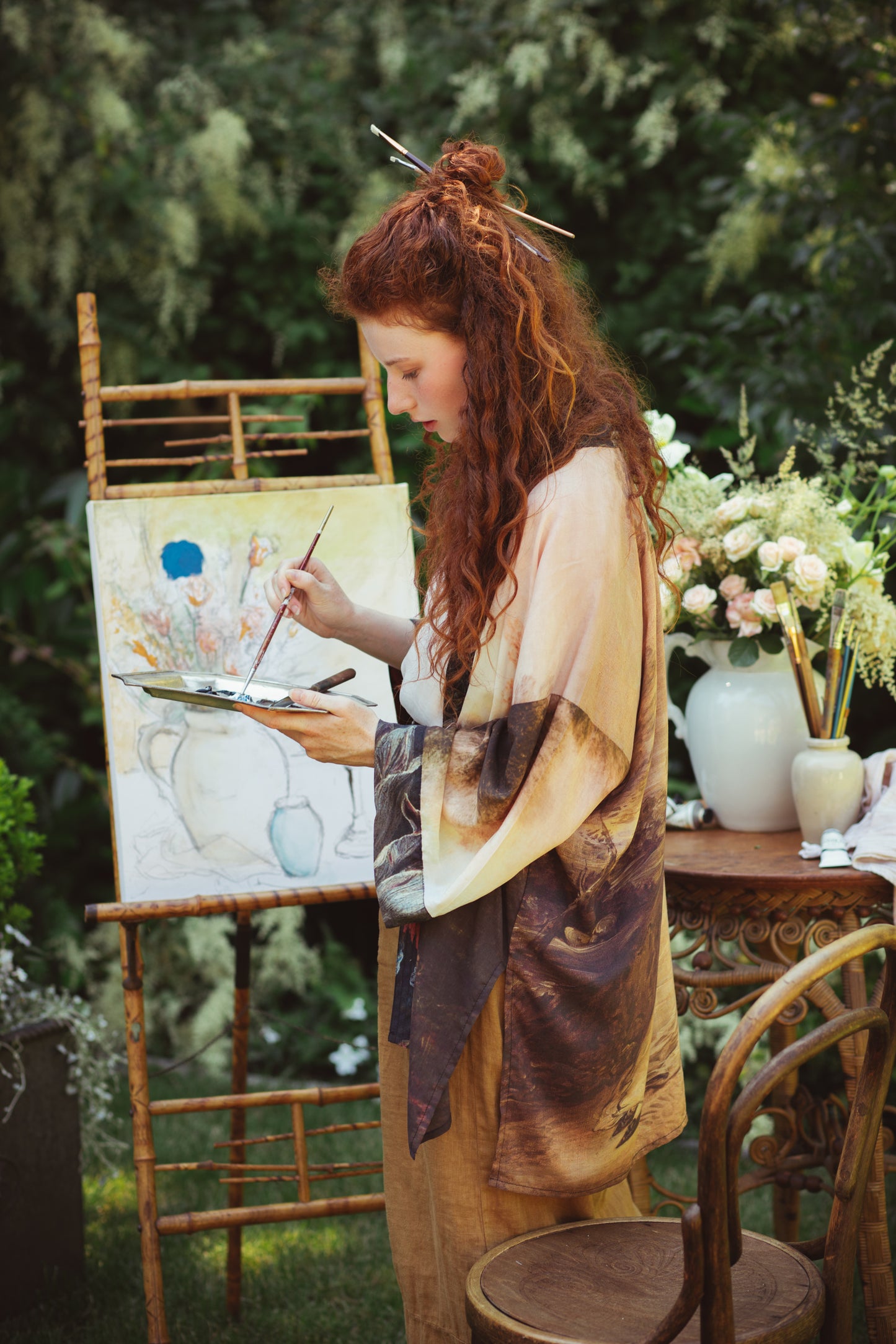 Model wearing The Artist kimono-style duster featuring antique paintings, botanical floral trim, and a radiant golden sun – Market of Stars