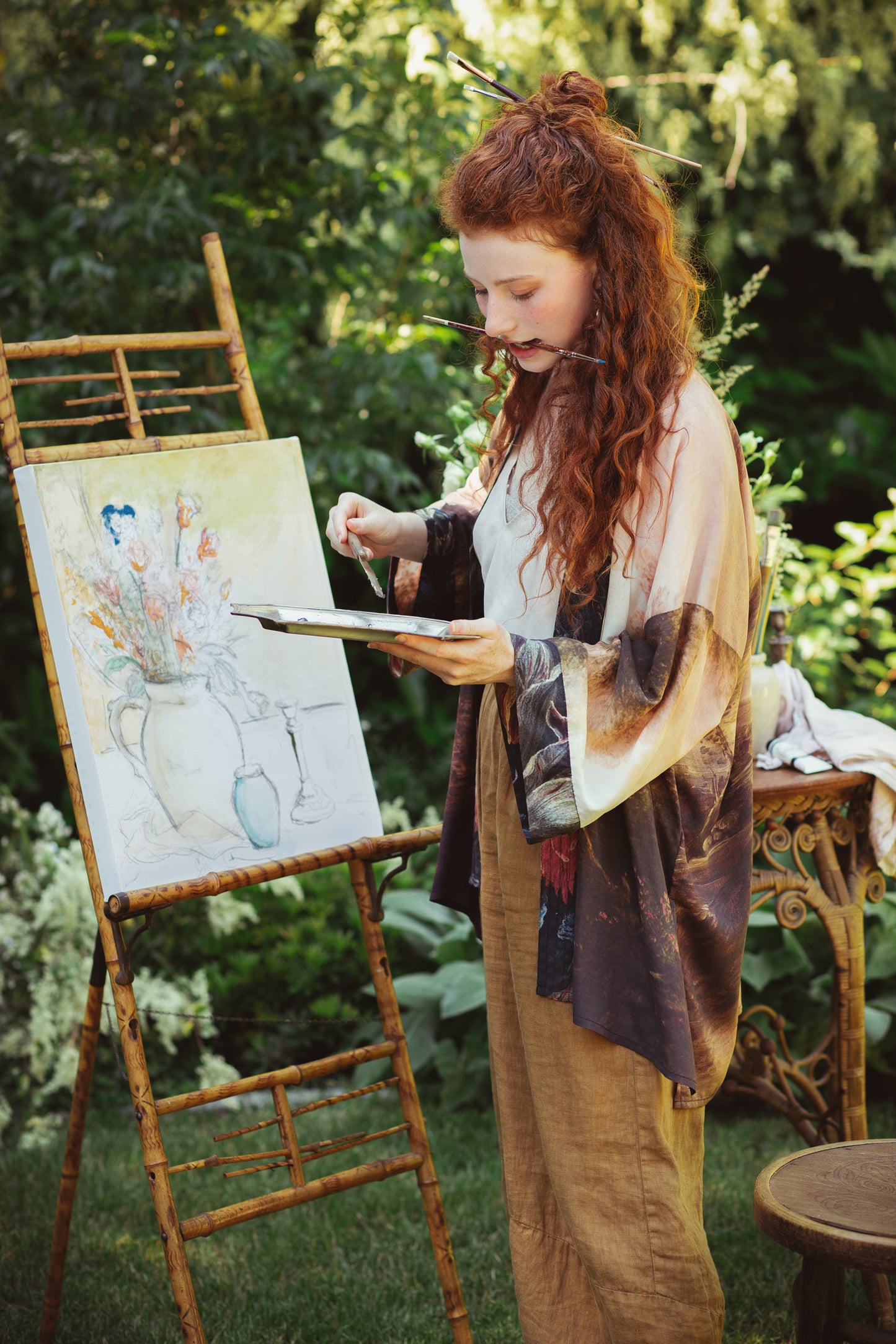 Model wearing The Artist kimono-style duster featuring antique paintings, botanical floral trim, and a radiant golden sun – Market of Stars