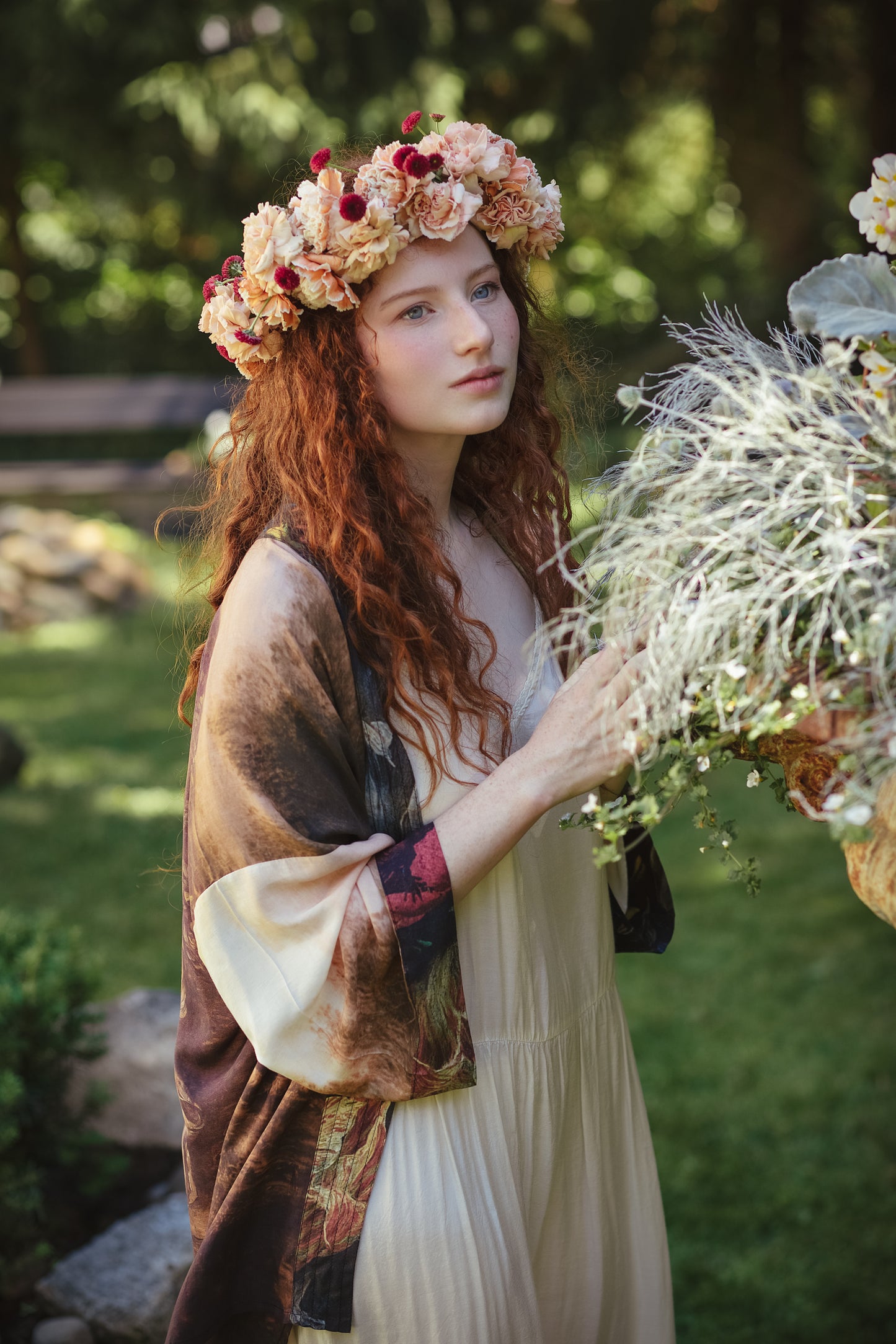 Model wearing The Artist kimono-style duster featuring antique paintings, botanical floral trim, and a radiant golden sun – Market of Stars