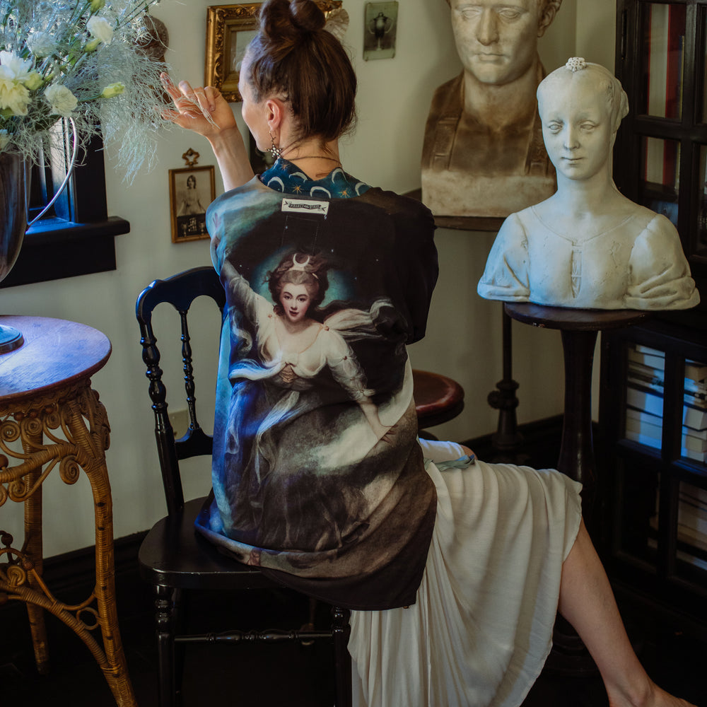 
                  
                    The Dreamer kimono jacket featuring a celestial Moon Goddess portrait with swirling sky detail and starry trim – Market of Stars
                  
                