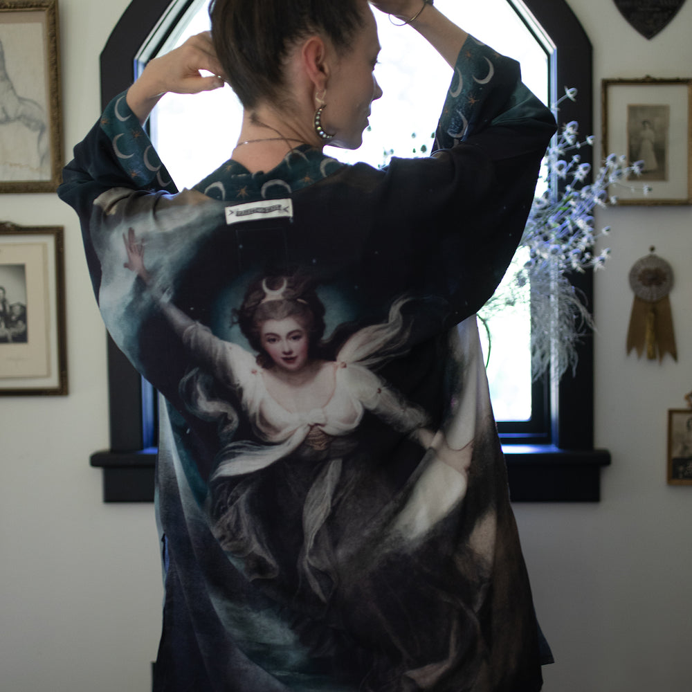 
                  
                    The Dreamer kimono jacket featuring a celestial Moon Goddess portrait with swirling sky detail and starry trim – Market of Stars
                  
                