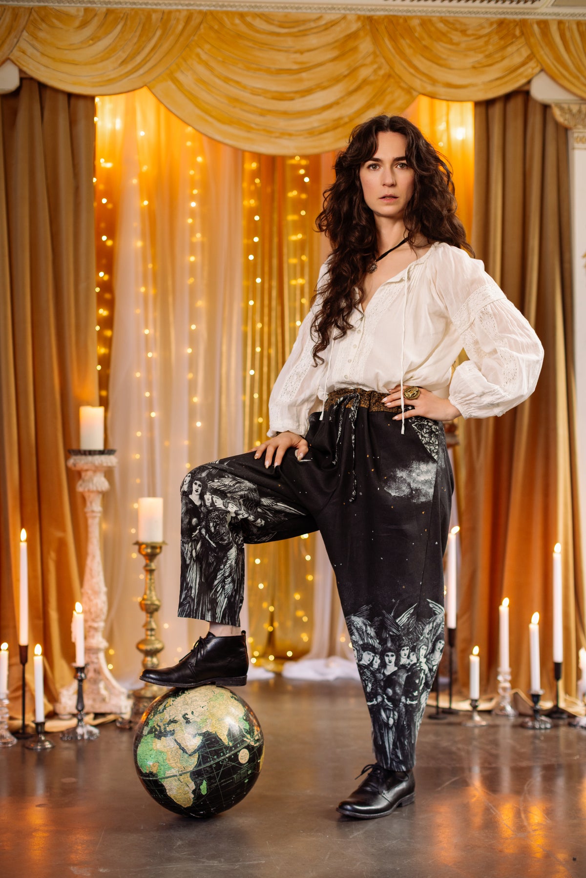 Model wearing a cropped linen blend pant with a celestial print ft. Burne-Jones angels, a moonlit sky, and vintage florals - Market of Stars.