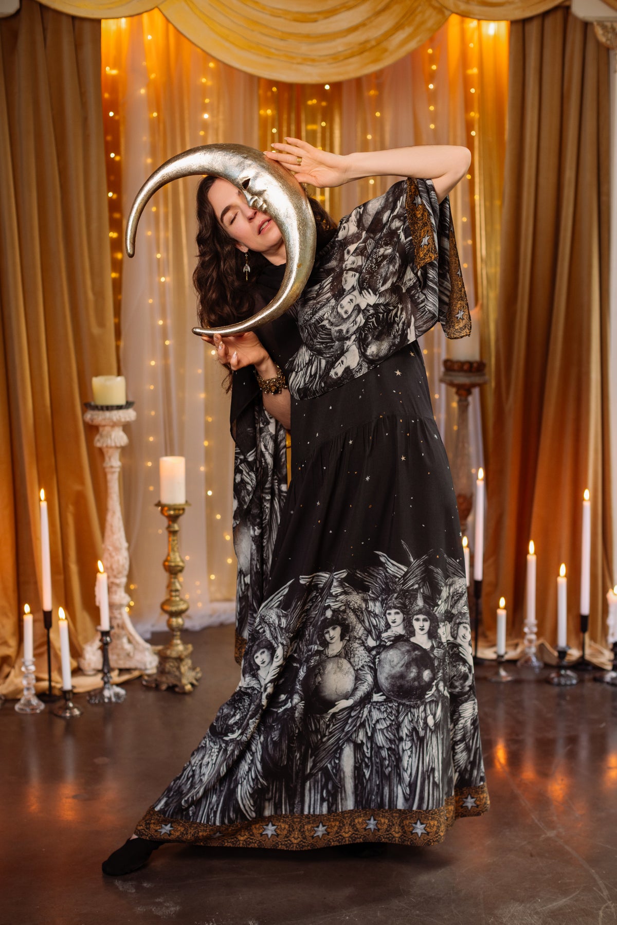 Model wearing a soft maxi-length slip dress with a celestial print ft. Burne-Jones angels, a moonlit sky, and vintage florals - Market of Stars.