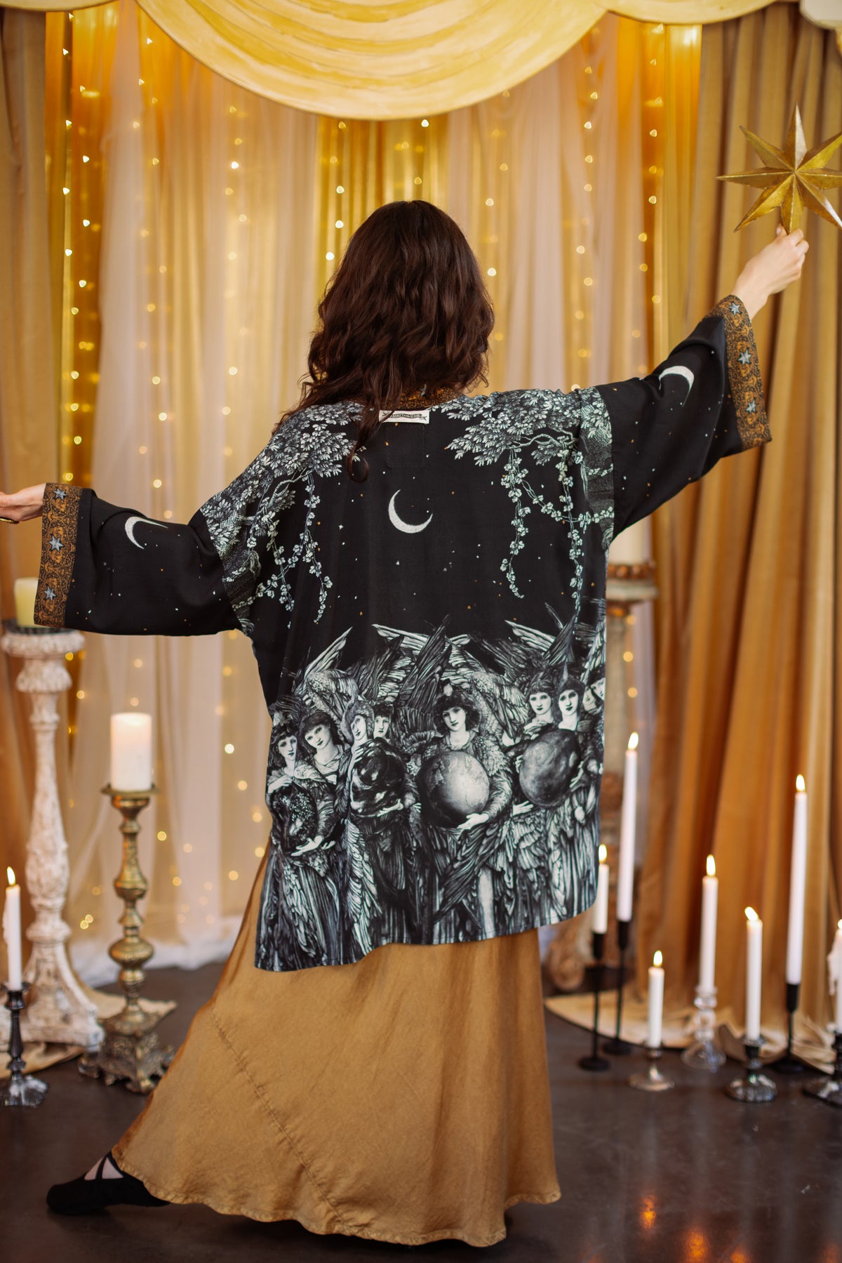 Model wearing a mid-length duster robe with a celestial print ft. Burne-Jones angels, a moonlit sky, and vintage florals - Market of Stars.
