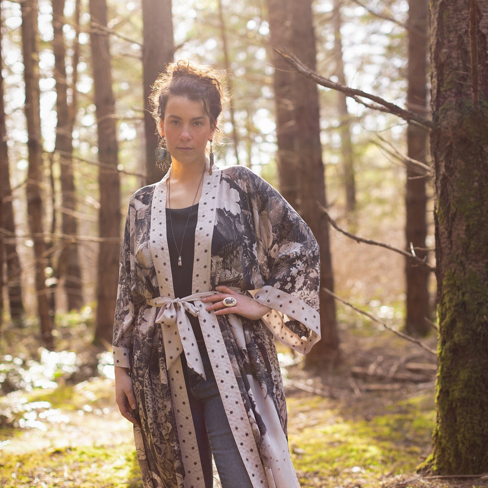 
                  
                    Model wearing Looking Glass Opera Robe featuring grown-up Alice Liddell, Victorian botanicals, and celestial star and moon accents inspired by Wonderland – Market of Stars.
                  
                