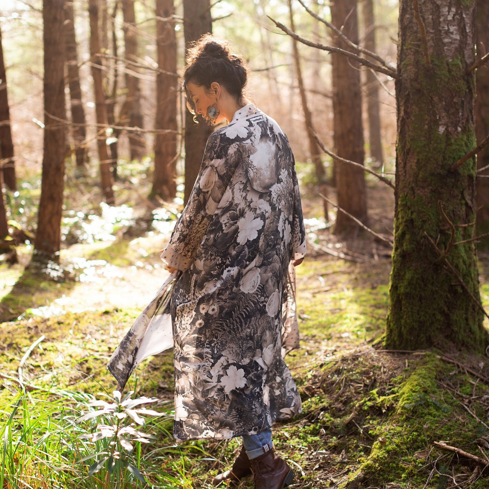 
                  
                    Model wearing Looking Glass Opera Robe featuring grown-up Alice Liddell, Victorian botanicals, and celestial star and moon accents inspired by Wonderland – Market of Stars.
                  
                