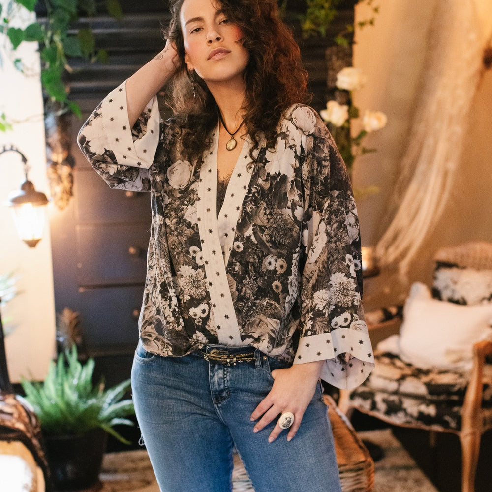 
                  
                    Model wearing Looking Glass Cropped Kimono featuring grown-up Alice Liddell, rare Victorian botanicals, and celestial star and moon accents inspired by Wonderland – Market of Stars.
                  
                