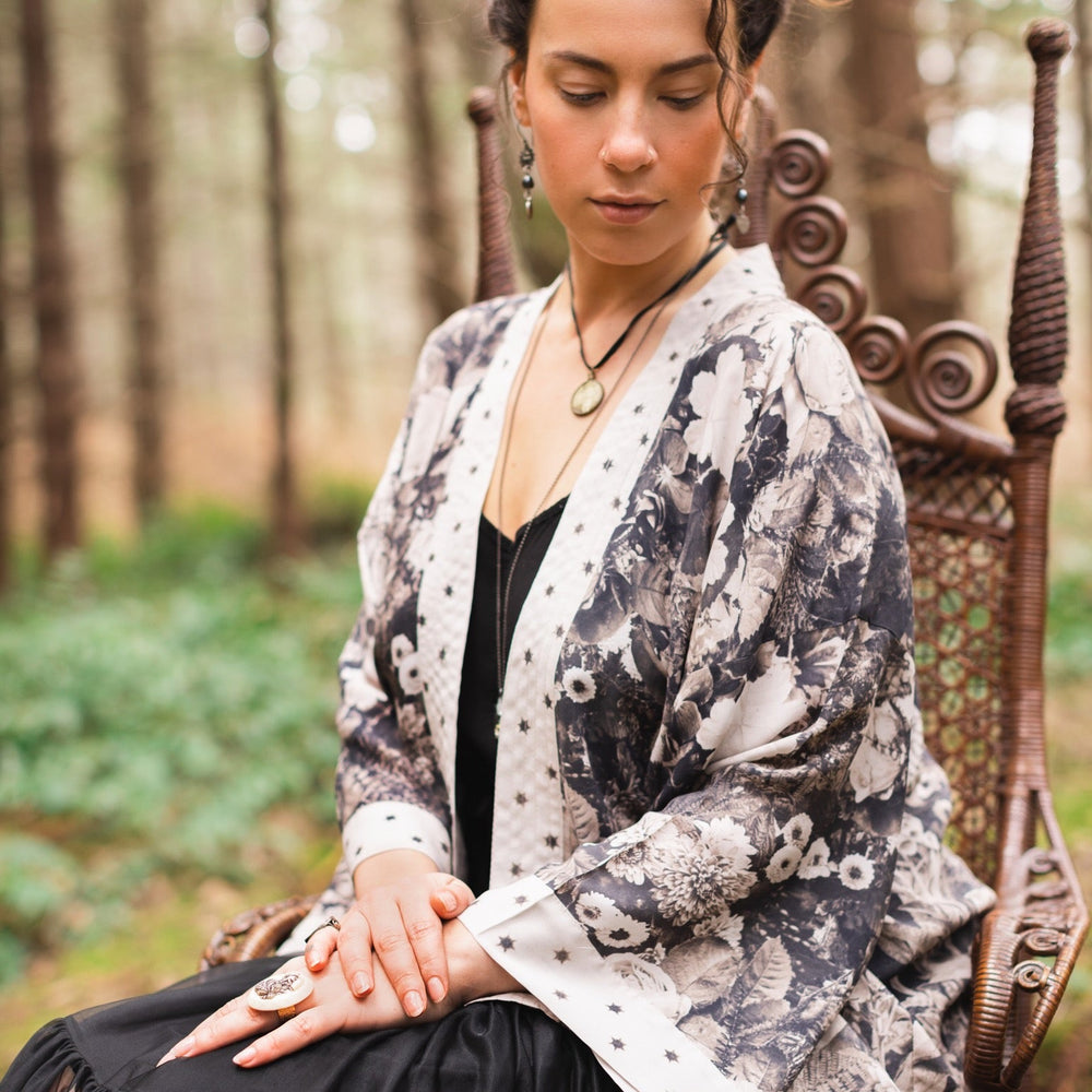 
                  
                    Model wearing Looking Glass Cropped Kimono featuring grown-up Alice Liddell, rare Victorian botanicals, and celestial star and moon accents inspired by Wonderland – Market of Stars.
                  
                
