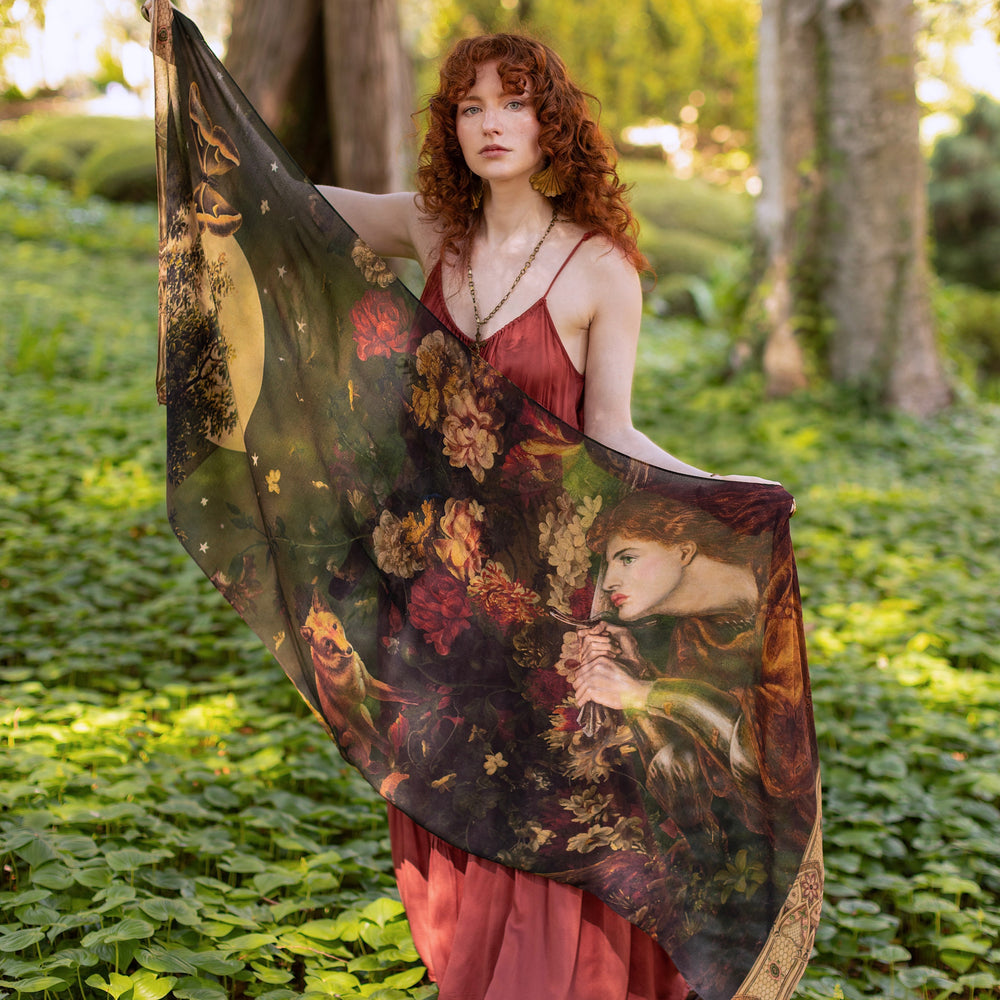 Model wearing a bamboo-viscose scarf featuring florals from centuries-old paintings and Rosetti’s iconic portrait of Joan of Arc - Market of Stars