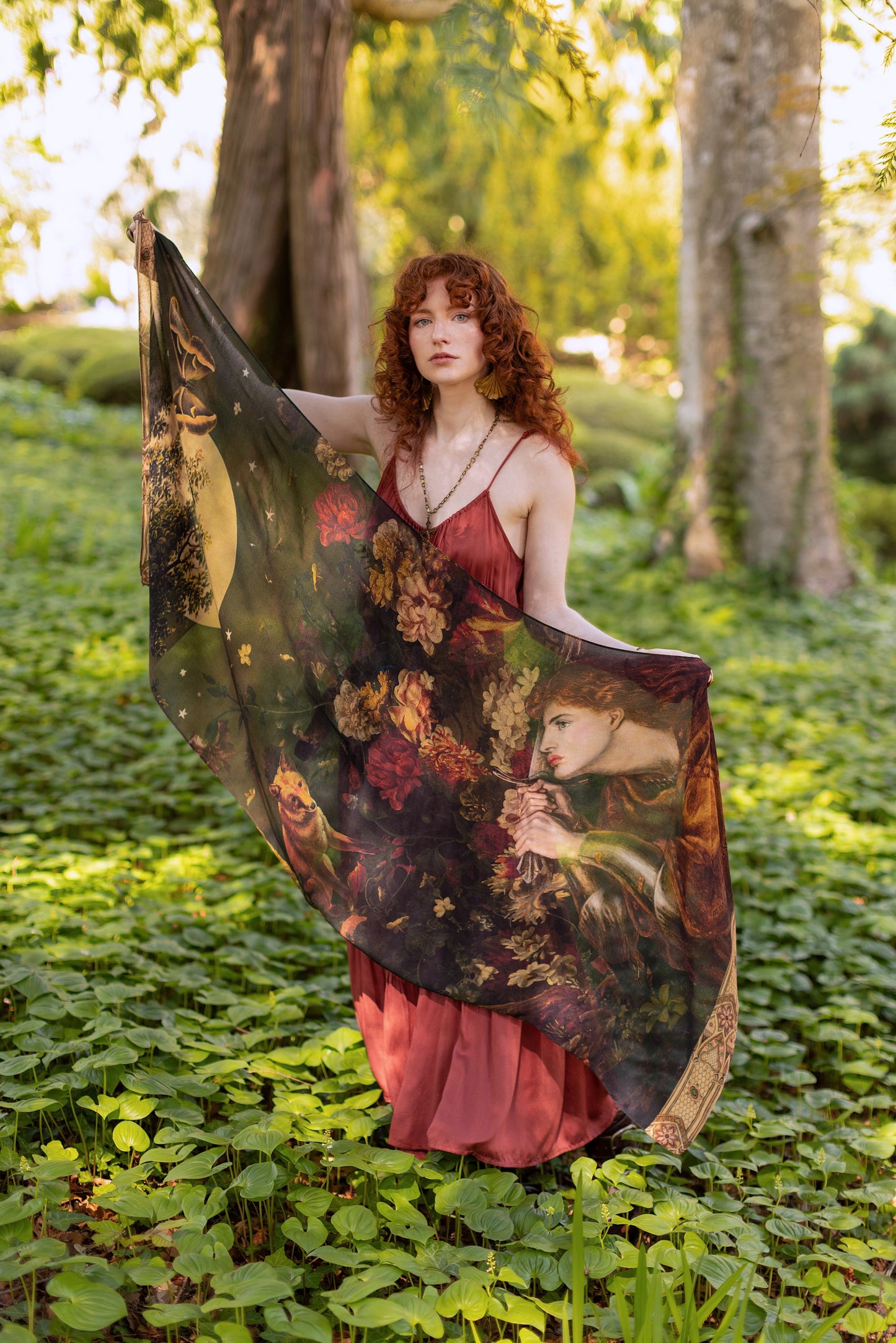 Model wearing a bamboo-viscose scarf featuring florals from centuries-old paintings and Rosetti’s iconic portrait of Joan of Arc - Market of Stars