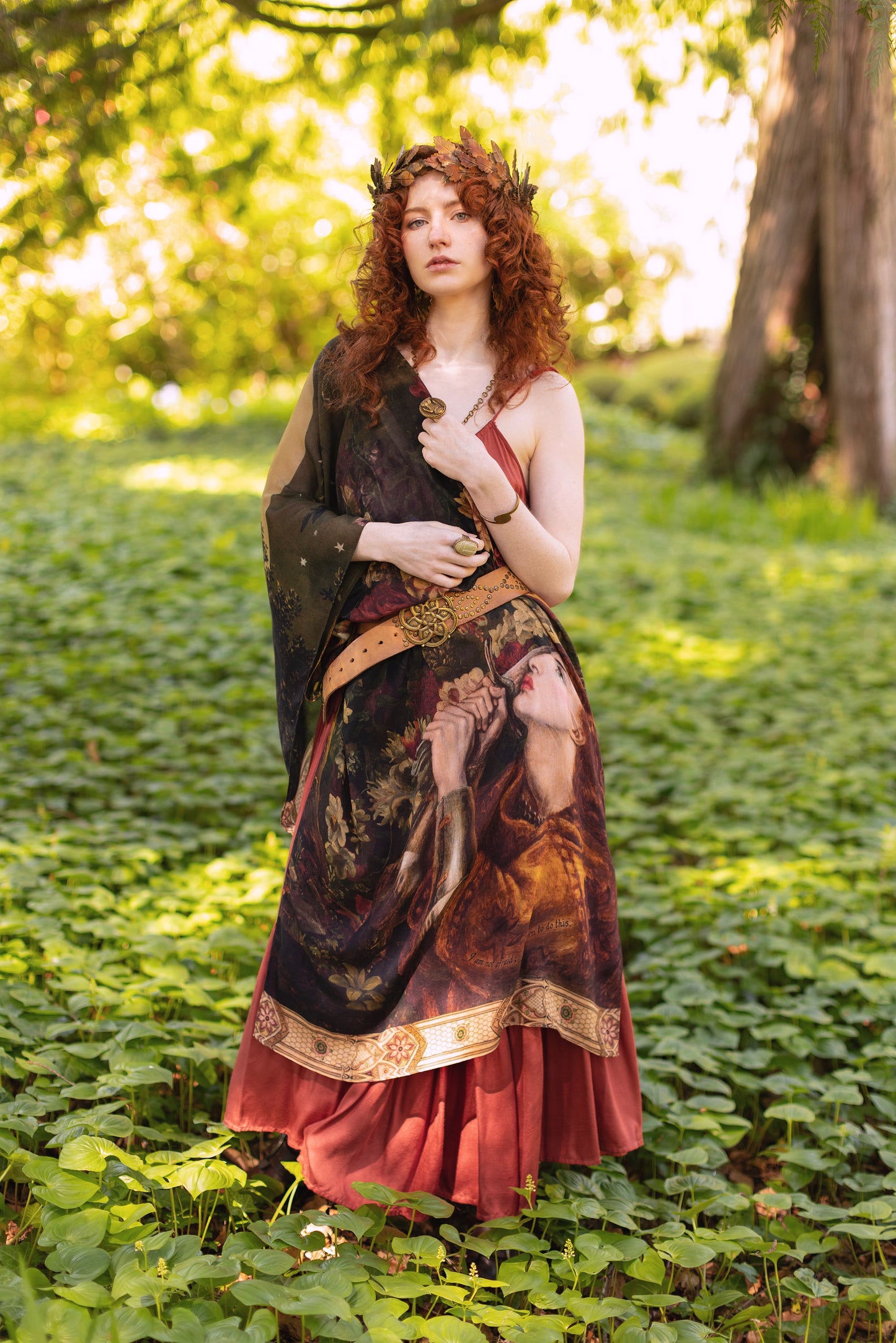 Model wearing a bamboo-viscose scarf featuring florals from centuries-old paintings and Rosetti’s iconic portrait of Joan of Arc - Market of Stars