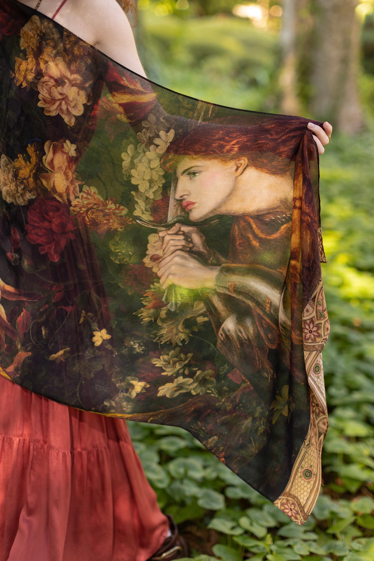 Model wearing a bamboo-viscose scarf featuring florals from centuries-old paintings and Rosetti’s iconic portrait of Joan of Arc - Market of Stars
