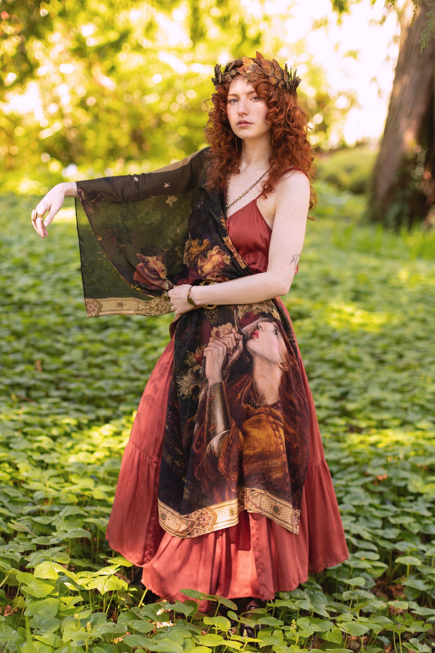 Model wearing a bamboo-viscose scarf featuring florals from centuries-old paintings and Rosetti’s iconic portrait of Joan of Arc - Market of Stars