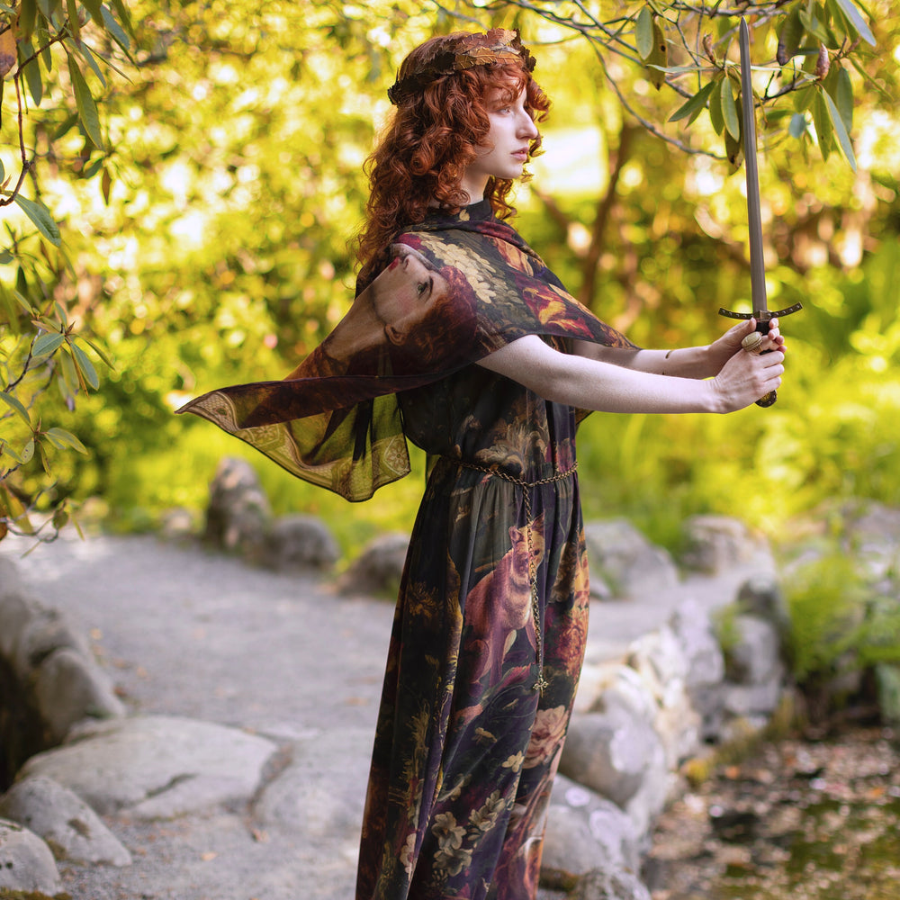 
                  
                    Model wearing a bamboo-viscose scarf featuring florals from centuries-old paintings and Rosetti’s iconic portrait of Joan of Arc - Market of Stars
                  
                