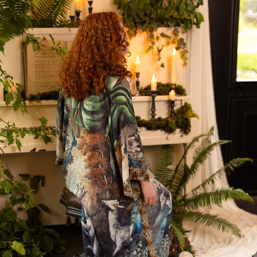 
                  
                    Model wearing the Theatre of Dreams Opera Duster featuring whimsical birds, love letters, and richly painted curtains by artist Jennifer Lanne – Market of Stars
                  
                