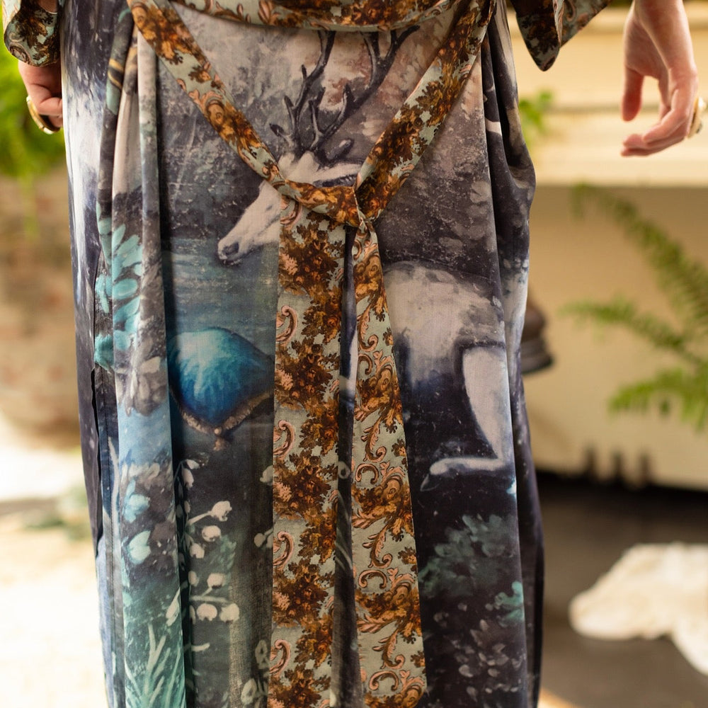 
                  
                    Model wearing the Theatre of Dreams Opera Duster featuring whimsical birds, love letters, and richly painted curtains by artist Jennifer Lanne – Market of Stars
                  
                