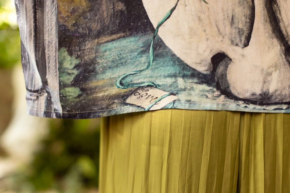
                  
                    Model wearing the cropped Theatre of Dreams kimono featuring painted swan, antique script, and whimsical theatre imagery from artist Jennifer Lanne
                  
                