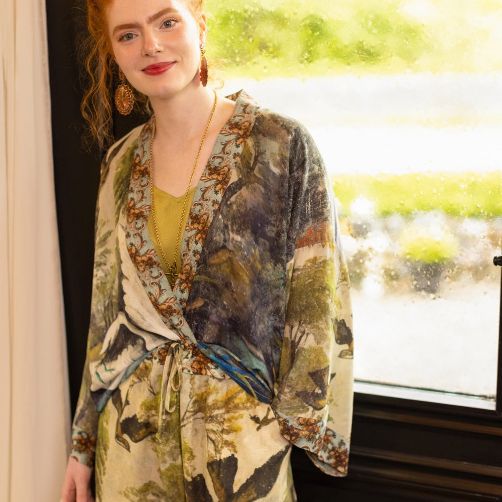 
                  
                    Model wearing Theatre of Dreams Artist Pants with lantern-hem silhouette featuring antique landscape, swan, and painted birds by artist Jennifer Lanne
                  
                